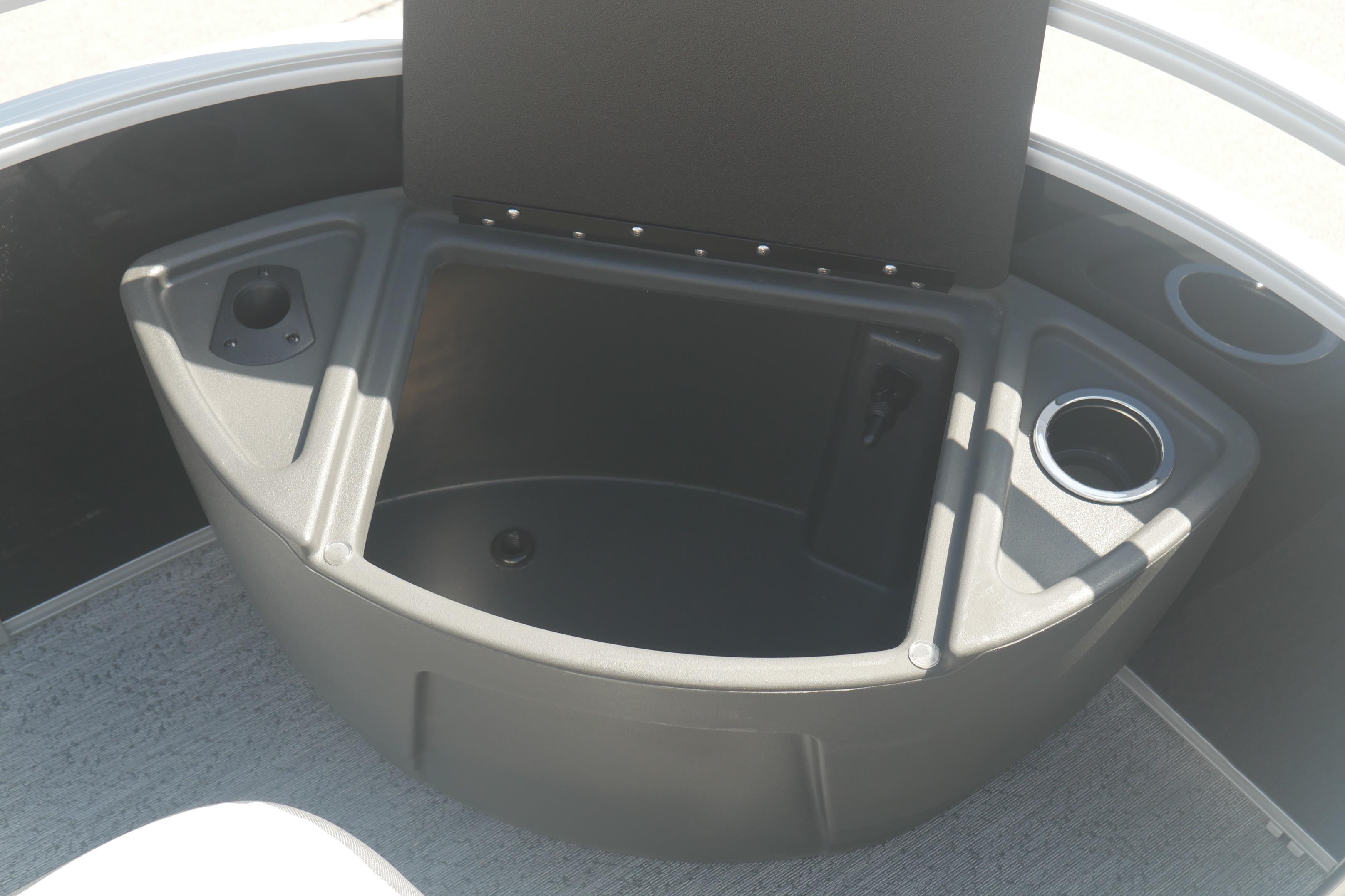 2026 Sun Tracker Fishin' Barge 20 DLX boat storage compartment with cup holders.