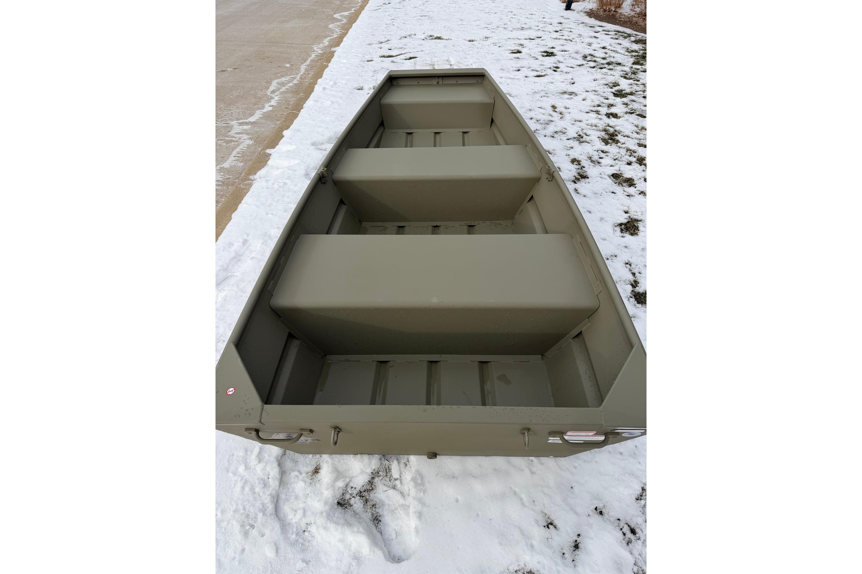2024 Tracker Grizzly 1036 Jon boat on snowy ground, showcasing interior seating.