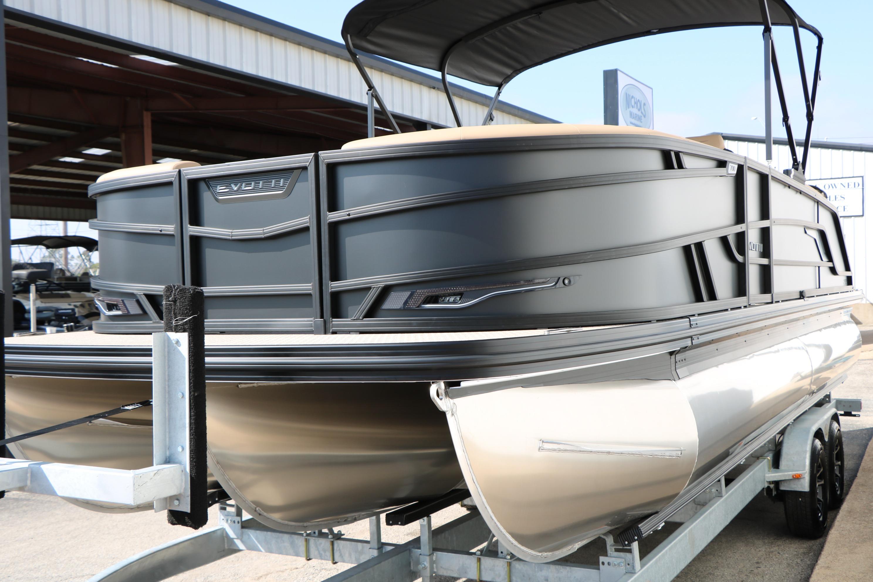 2026 Evotti 723CS pontoon boat on trailer, sleek design, outdoor display.