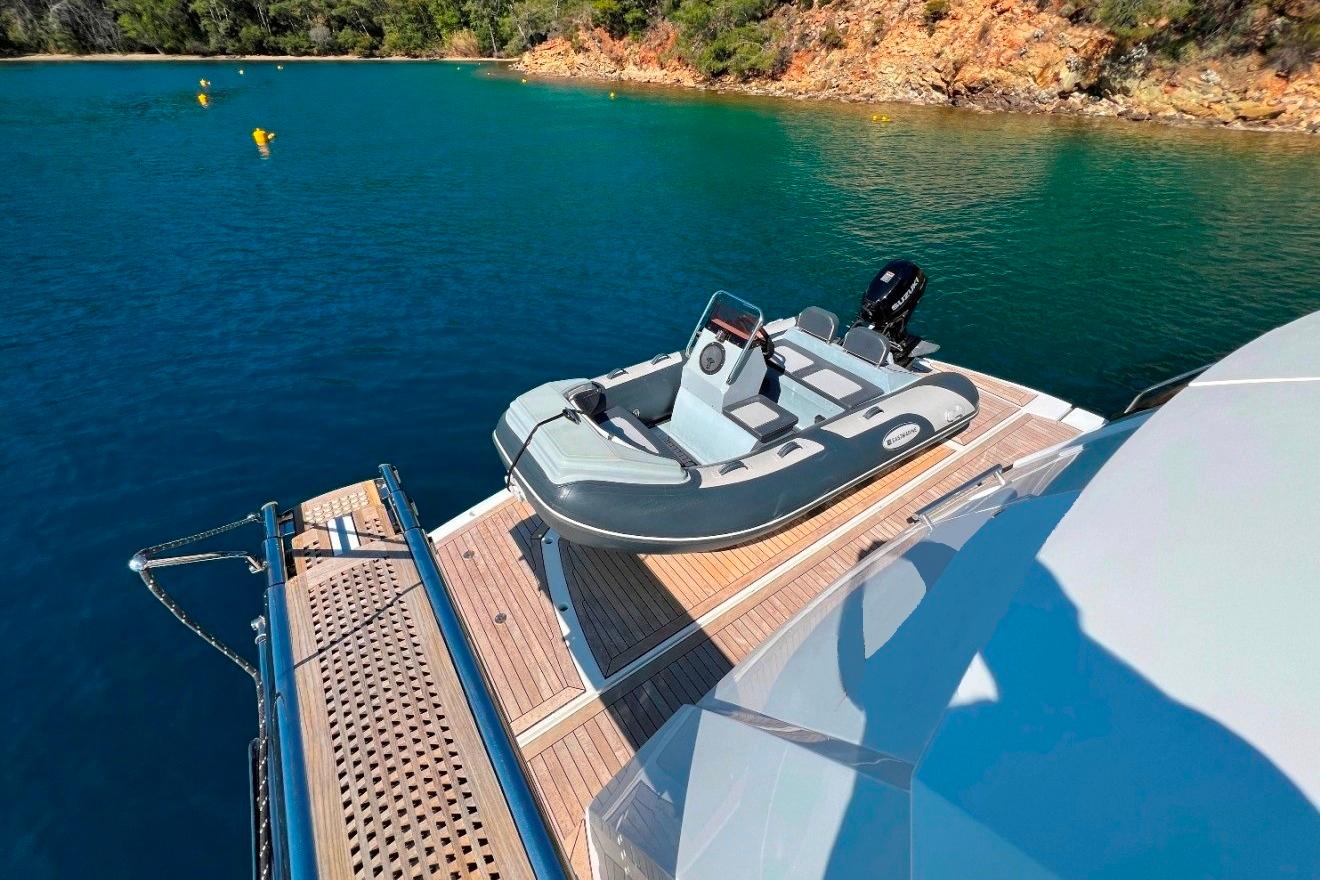 Sunseeker 80 Yacht 2011 with tender on deck, moored in scenic waters.
