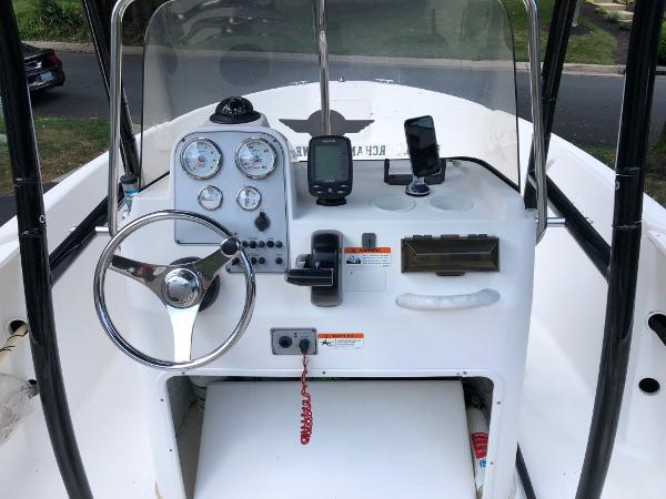 2003 Wellcraft 180 Fisherman boat console with steering wheel and navigation instruments.