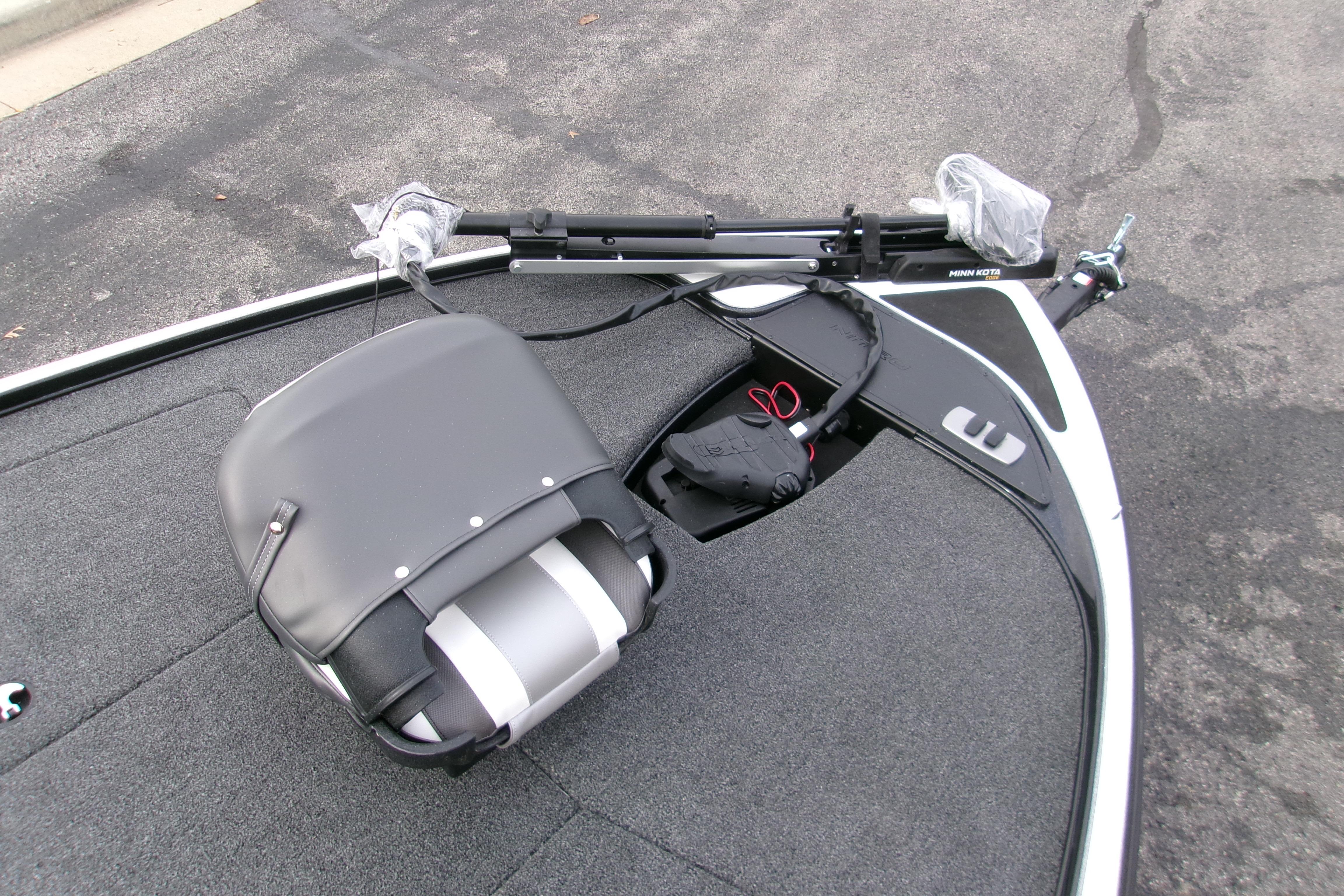 2026 Nitro Z17 boat deck with seat and trolling motor on asphalt.