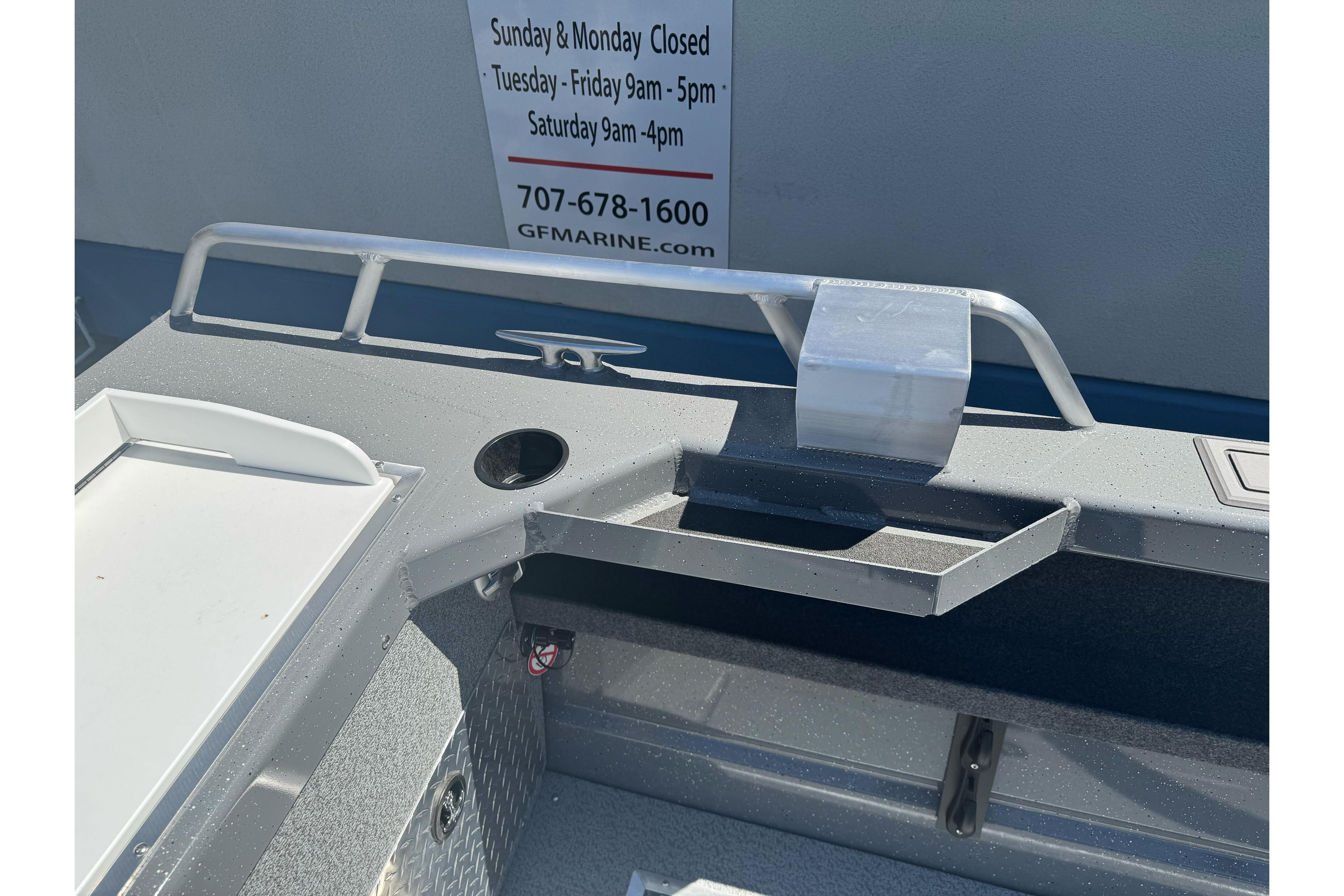 2026 Lund 210 Heavy Gauge boat interior with storage and railing details.