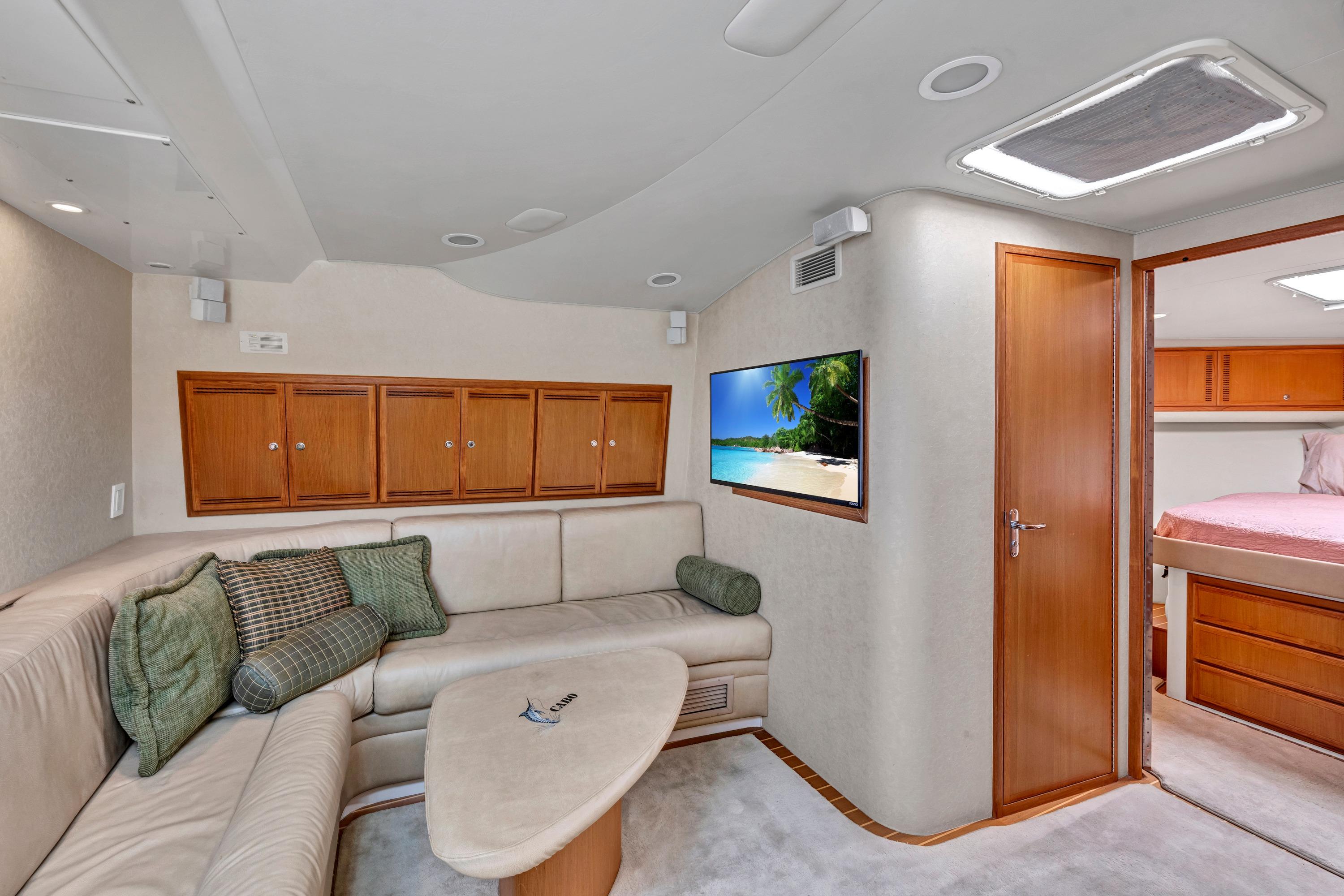 Luxurious interior of 2010 Cabo 45 Express yacht with cozy seating and modern amenities.