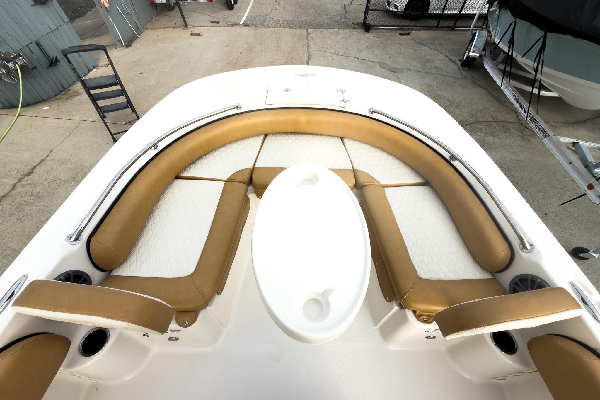 2025 Carolina Skiff 21 Ultra Elite boat interior with tan seating and white table.
