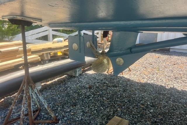 Underneath view of a 1997 Rosborough Trawler, showing propeller and keel on gravel.