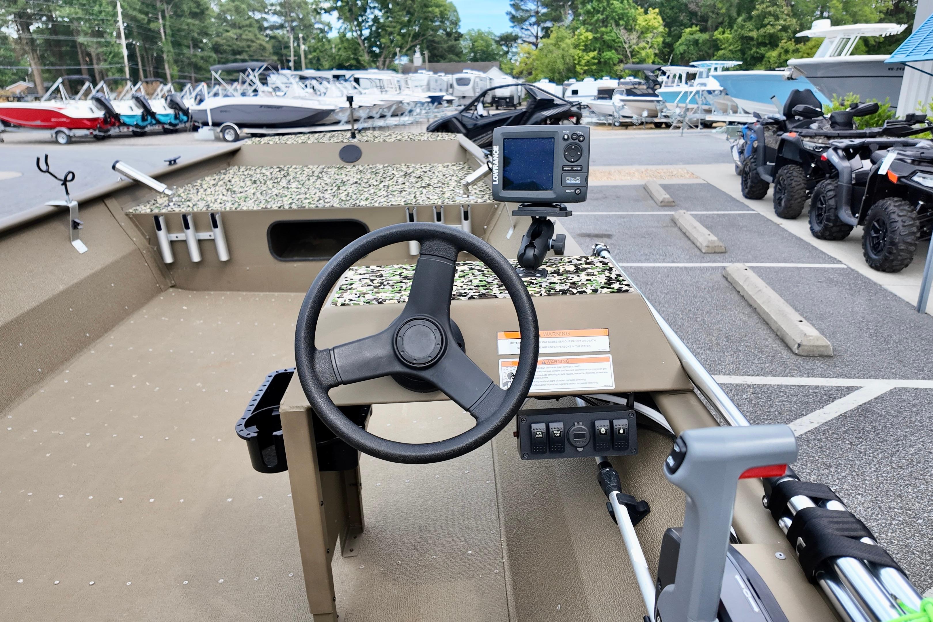 2025 G3 BOATS 1860 SC steering console with fish finder in a showroom.