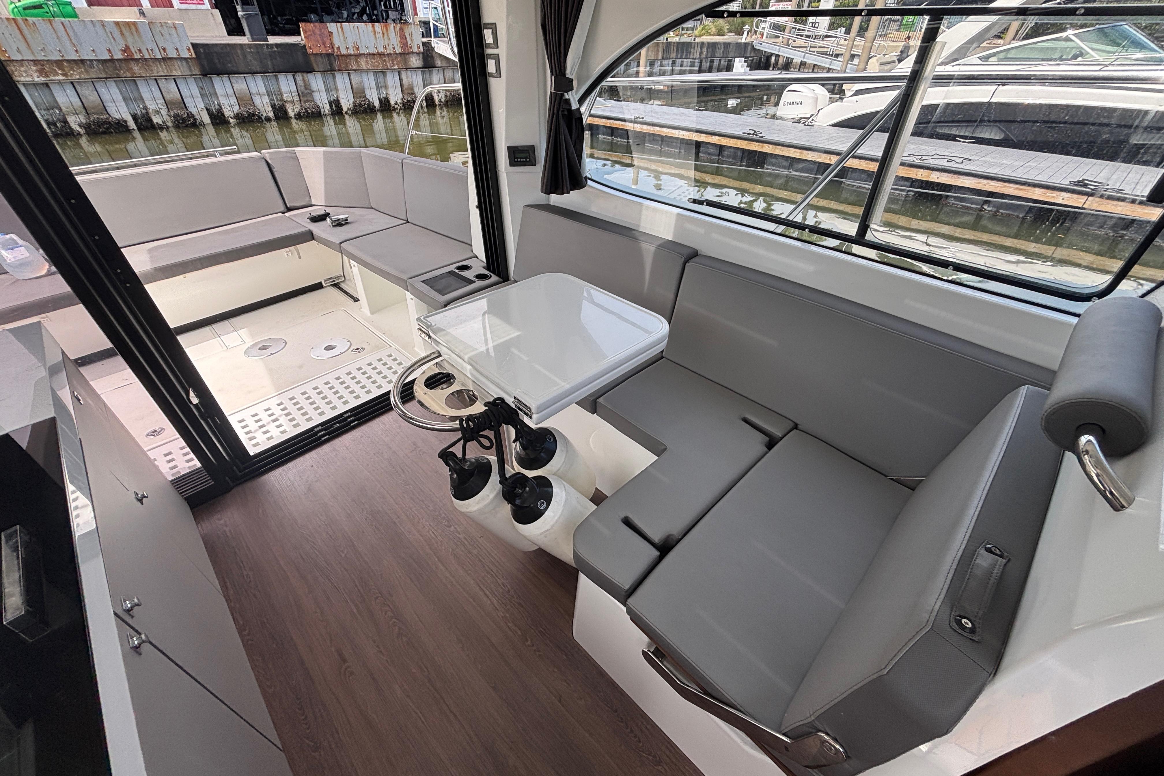 Interior of 2024 Beneteau Antares 11, featuring modern seating and dining area.