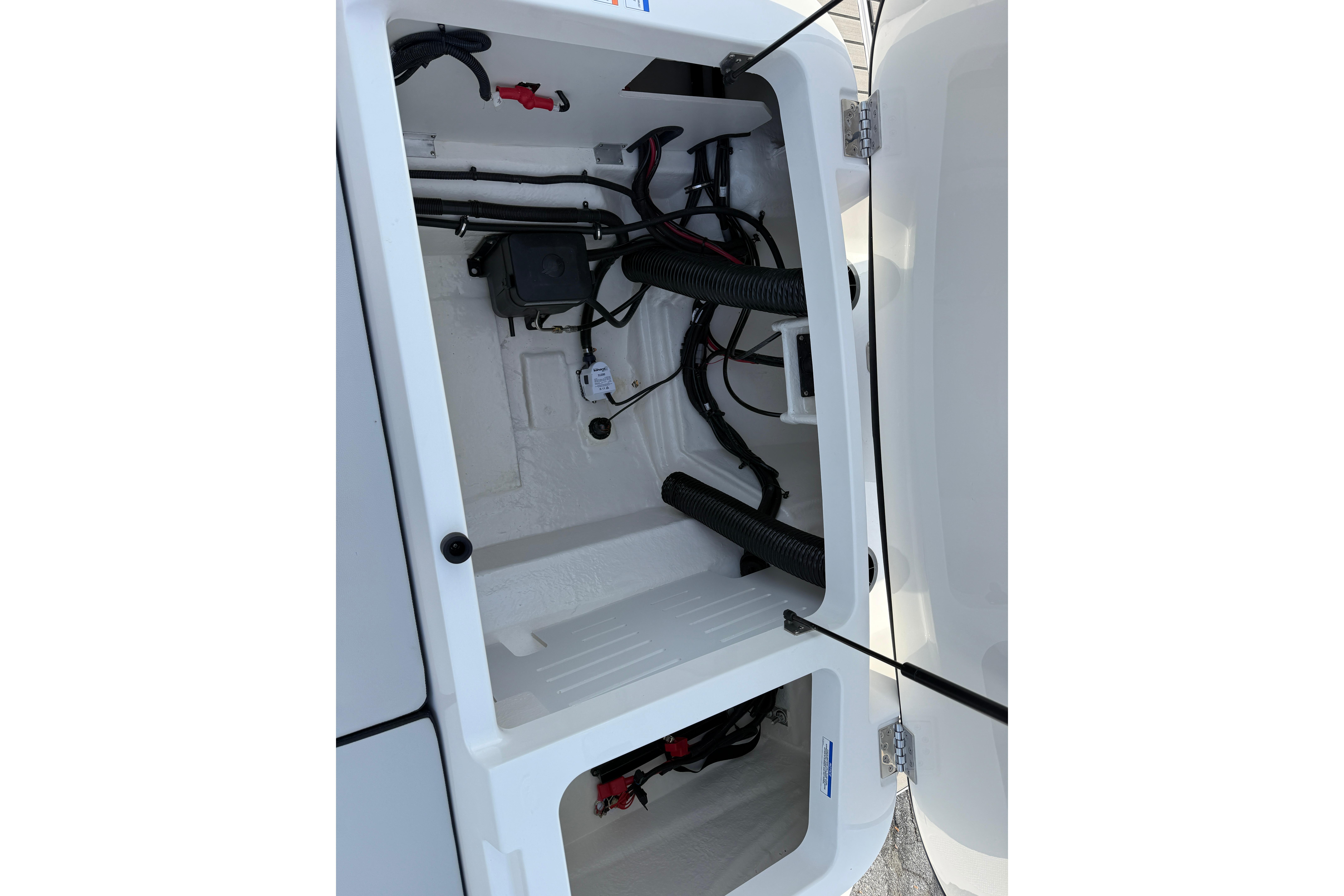 2026 Sea Ray SPX 210 Outboard storage compartment with visible wiring and components.