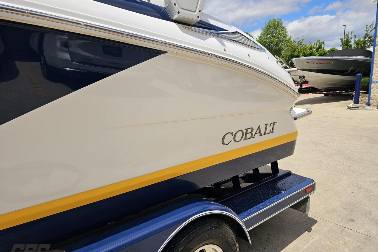 2010 Cobalt 232 WSS boat on trailer, featuring sleek design and vibrant colors.