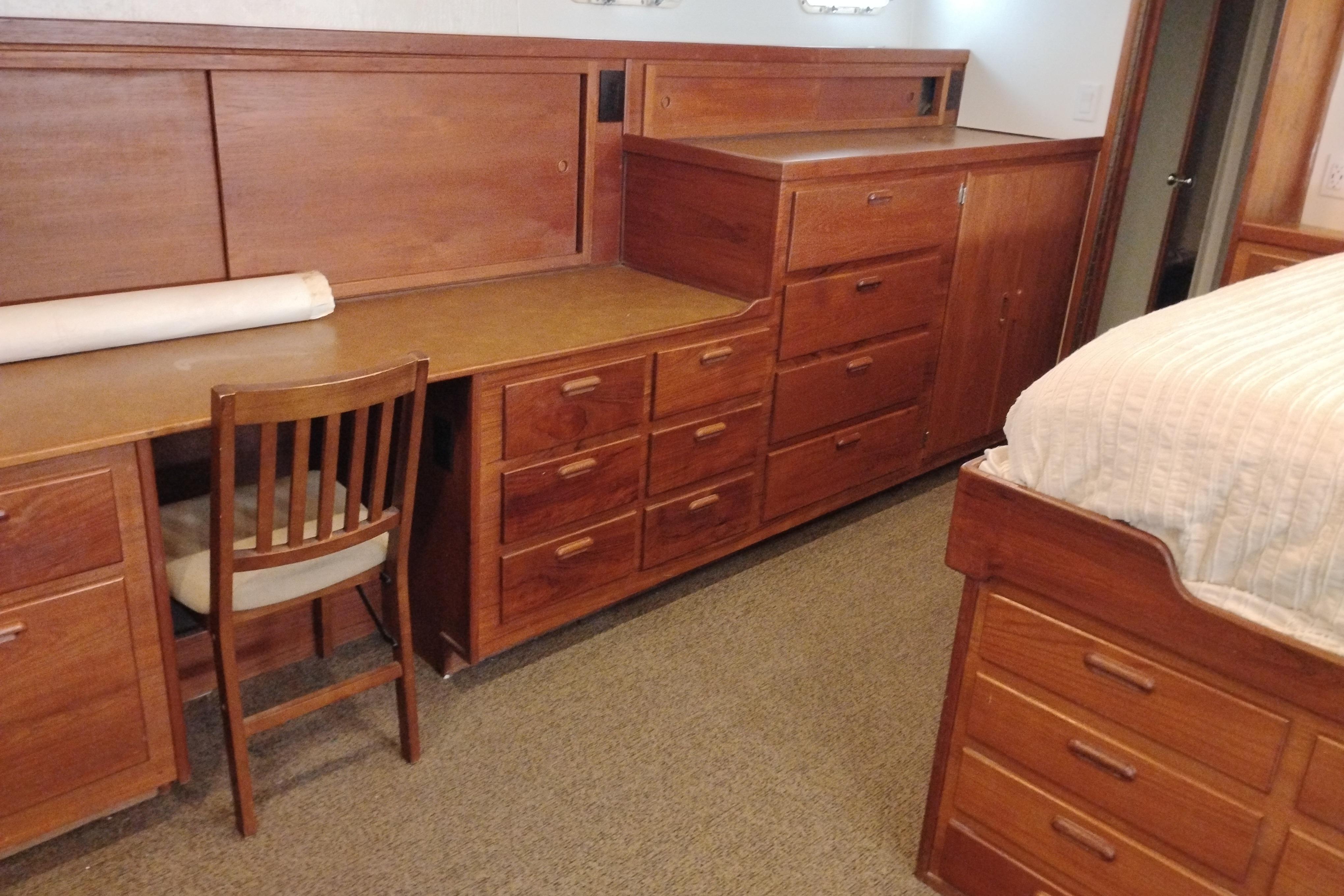 Wooden cabin interior with desk, drawers, and bed on a 1977 Custom International Offshore 65.