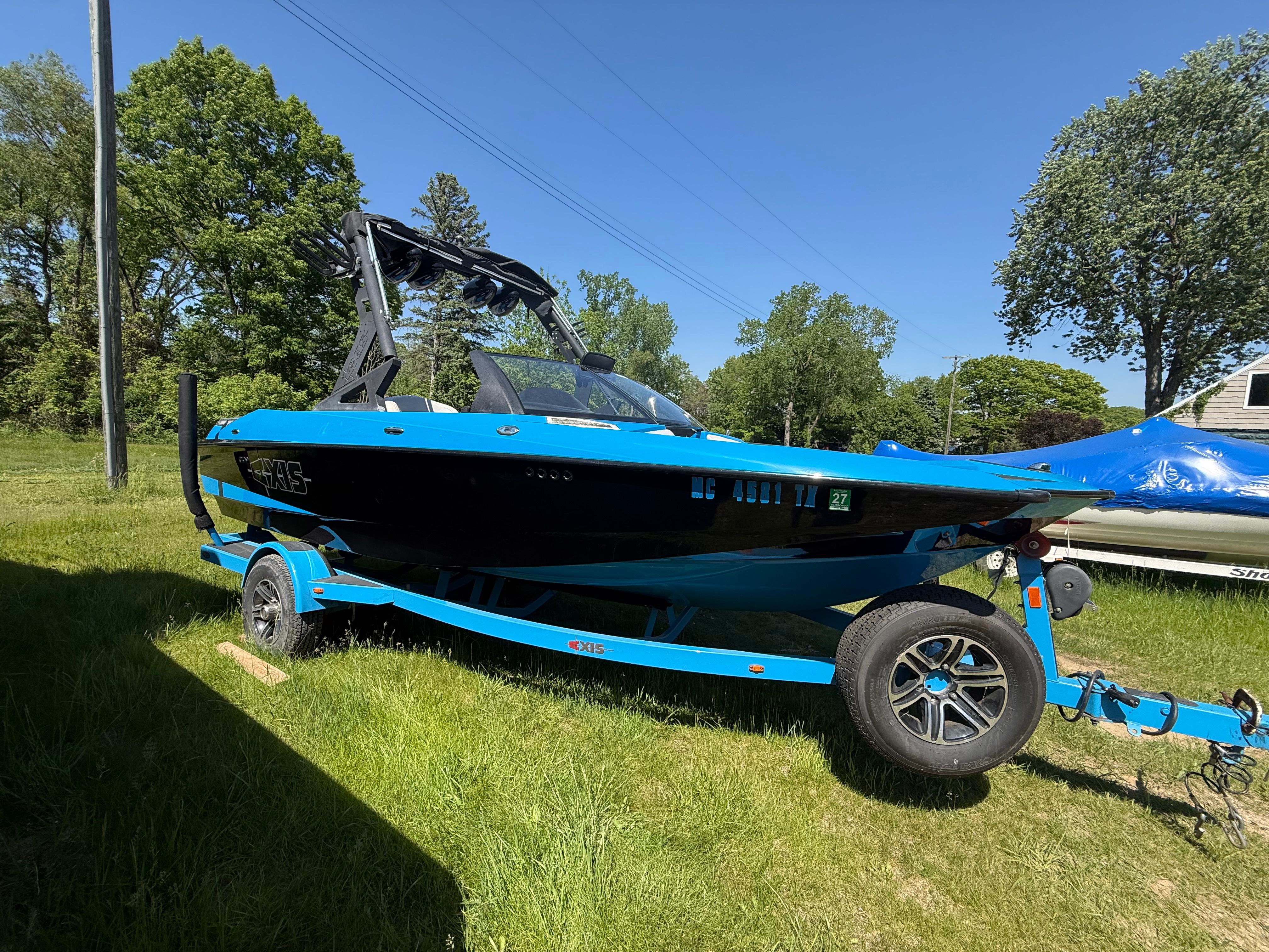 2015 Malibu Axis A20 boat on trailer outdoors.