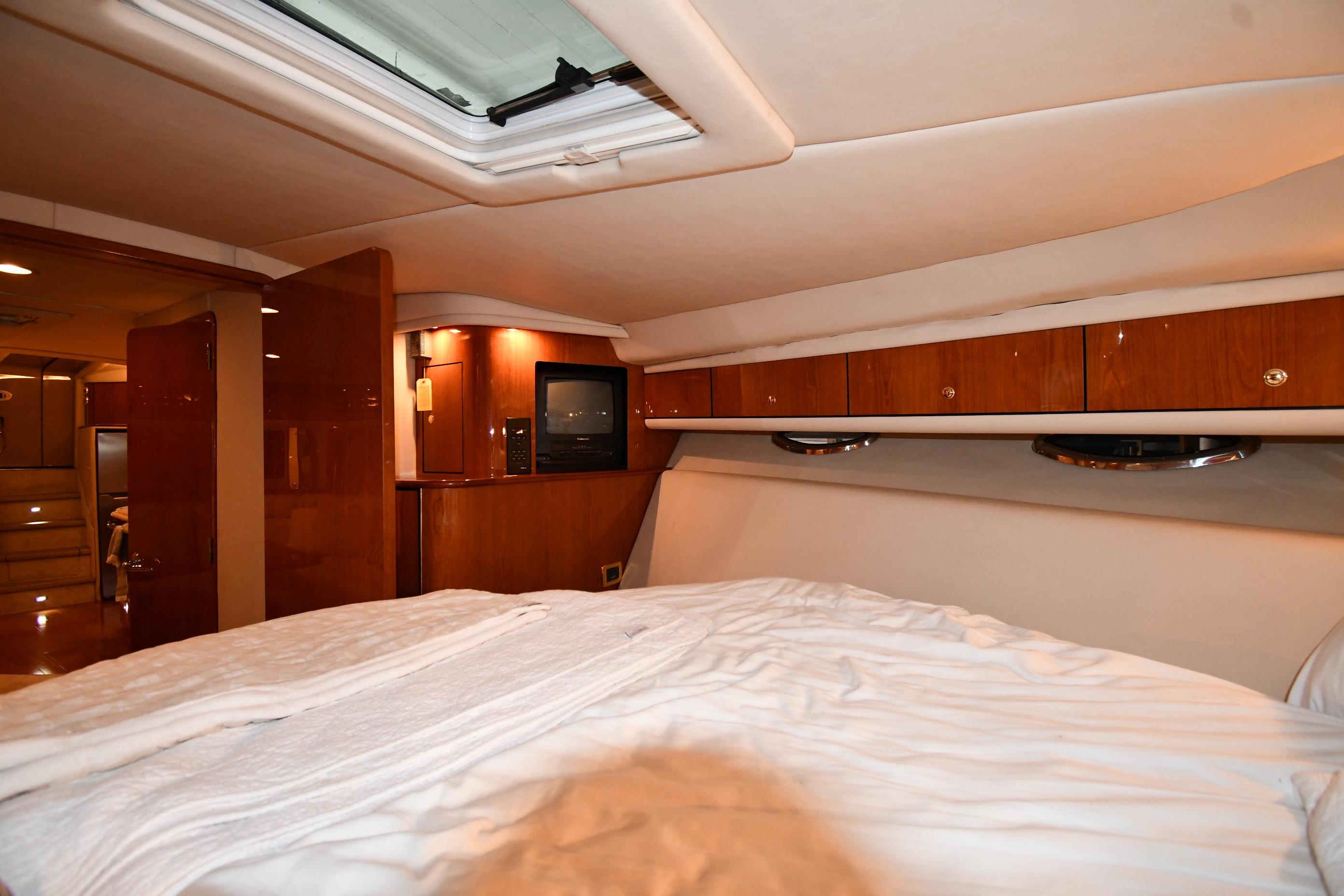 Luxurious interior of 2001 Sea Ray 540 Sundancer yacht with cozy bedroom.