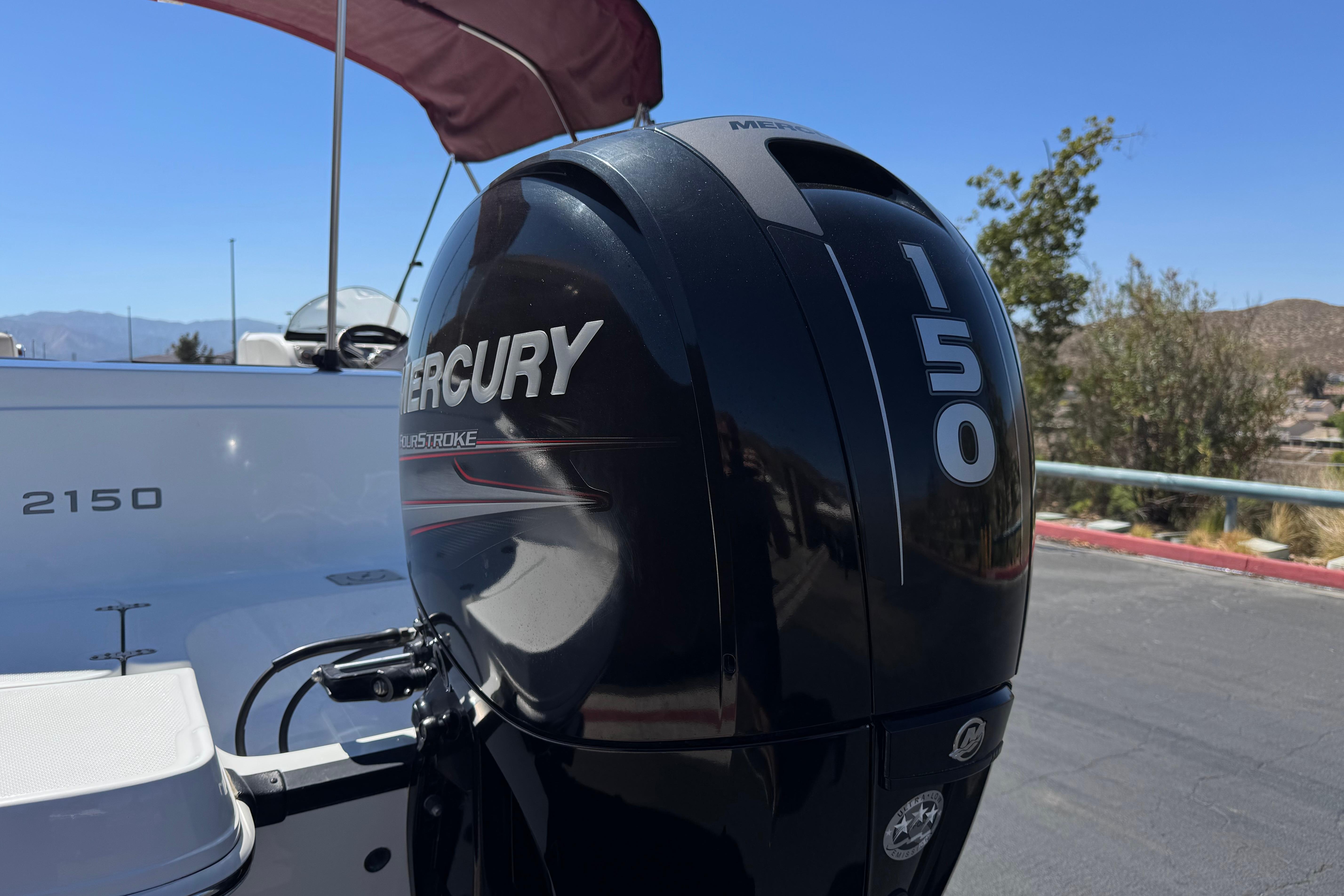 2017 Tahoe 2150 boat with Mercury 150 outboard motor in sunny setting.