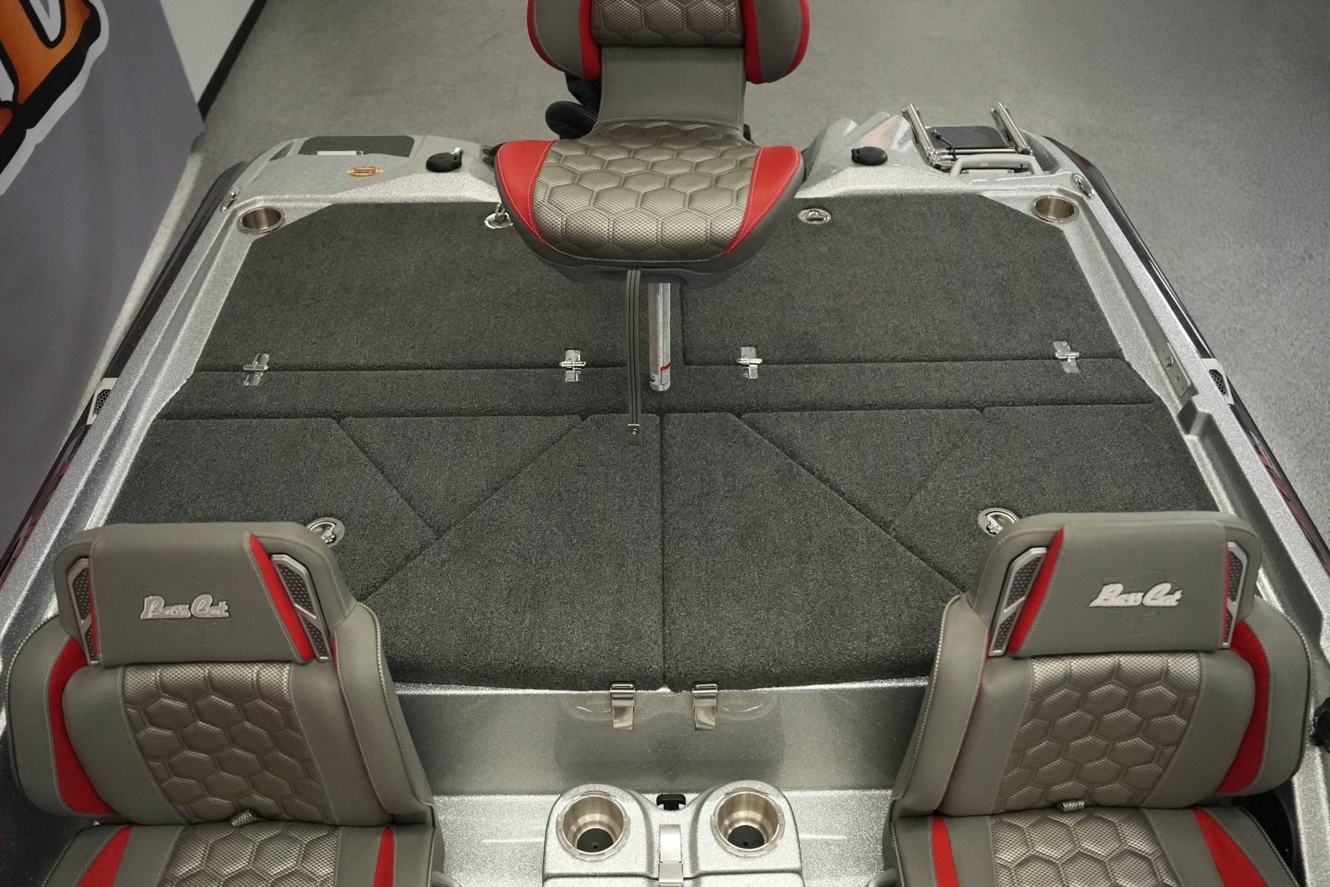 2026 Bass Cat Lynx STS boat interior with gray and red seating and carpeted deck.