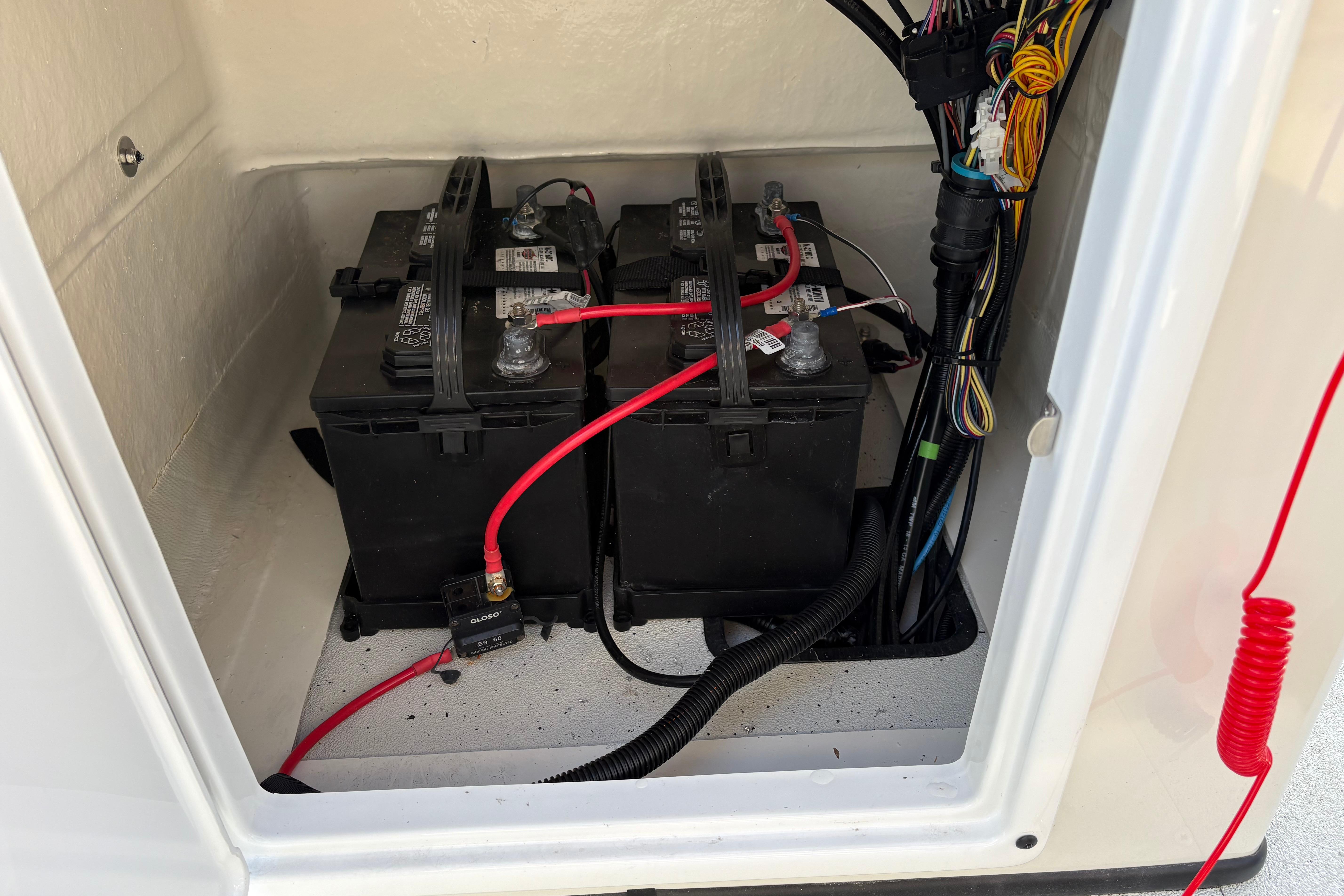 Battery compartment of 2026 Ranger RB200 with wiring and connections.