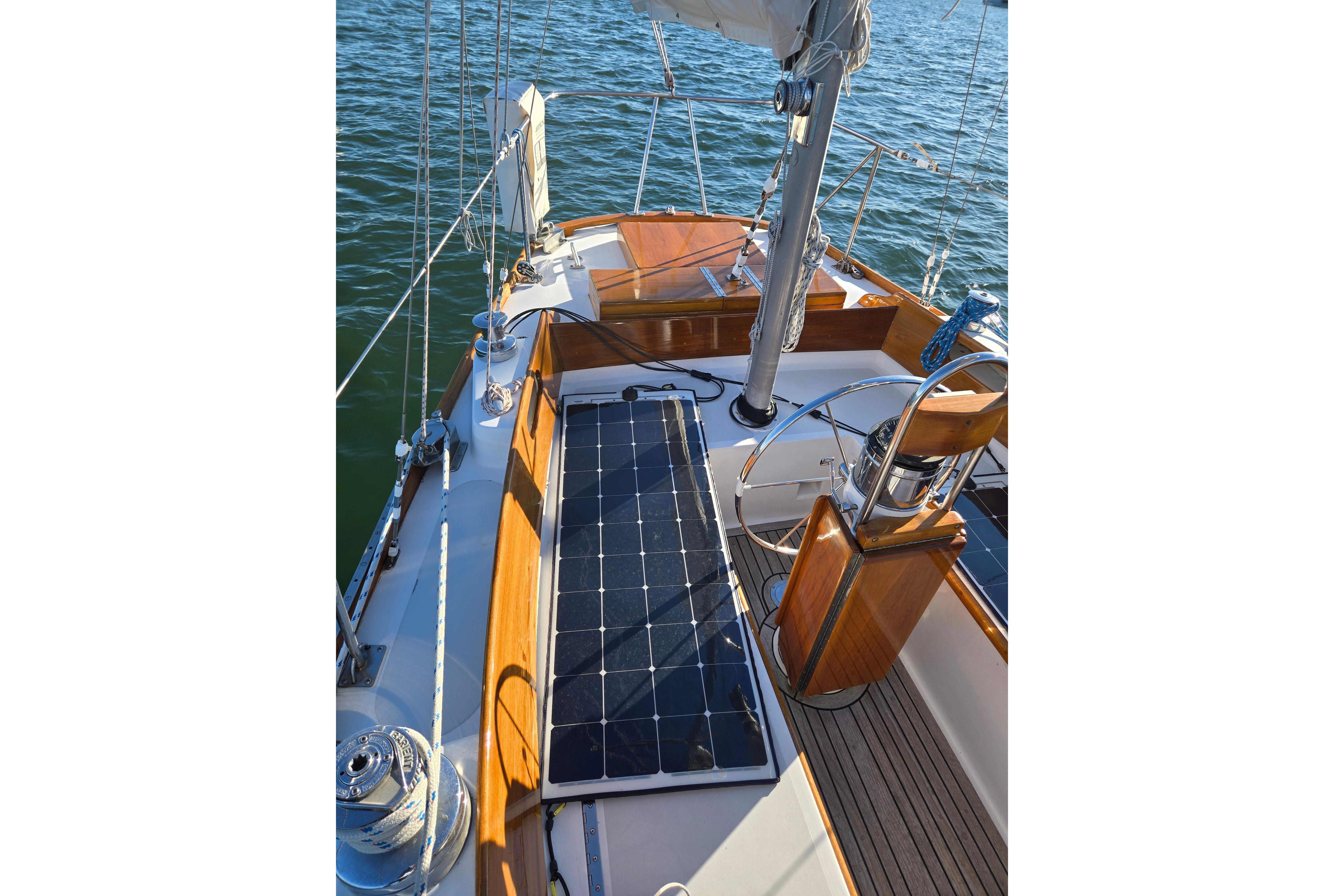 1970 Hinckley Bermuda 40 sailboat deck with solar panel and wooden accents.
