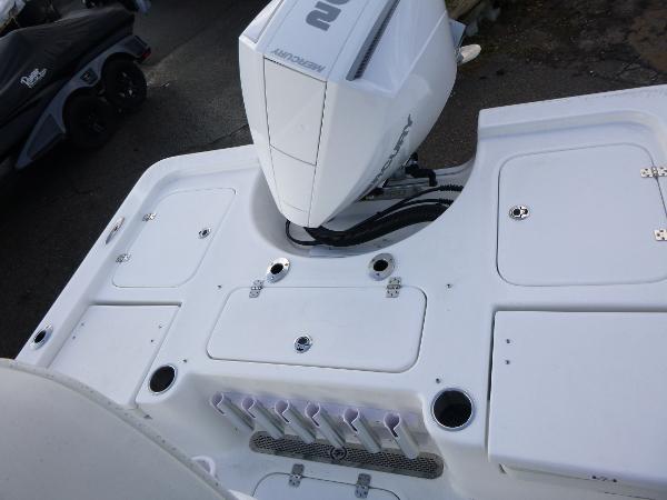 2025 Sea Pro 230 Bay boat deck with motor and storage compartments.