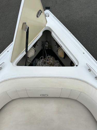 Open storage compartment on 2010 Cobalt 262 boat with ropes and equipment.