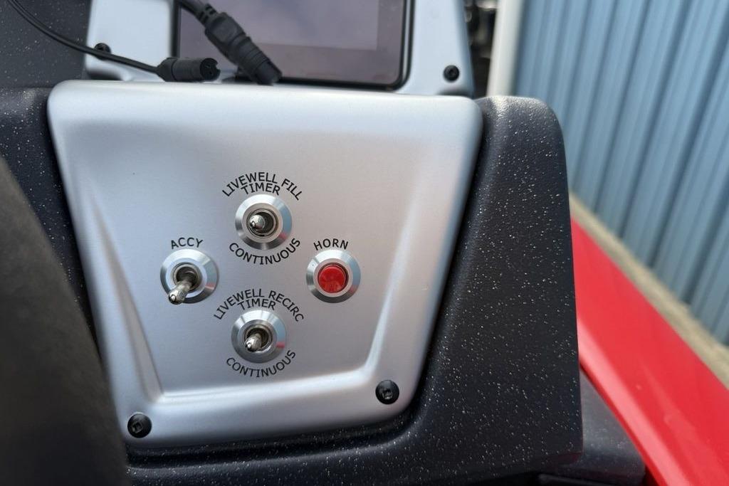 Control panel of 2026 Tracker Pro Team 175 boat with switches and horn button.