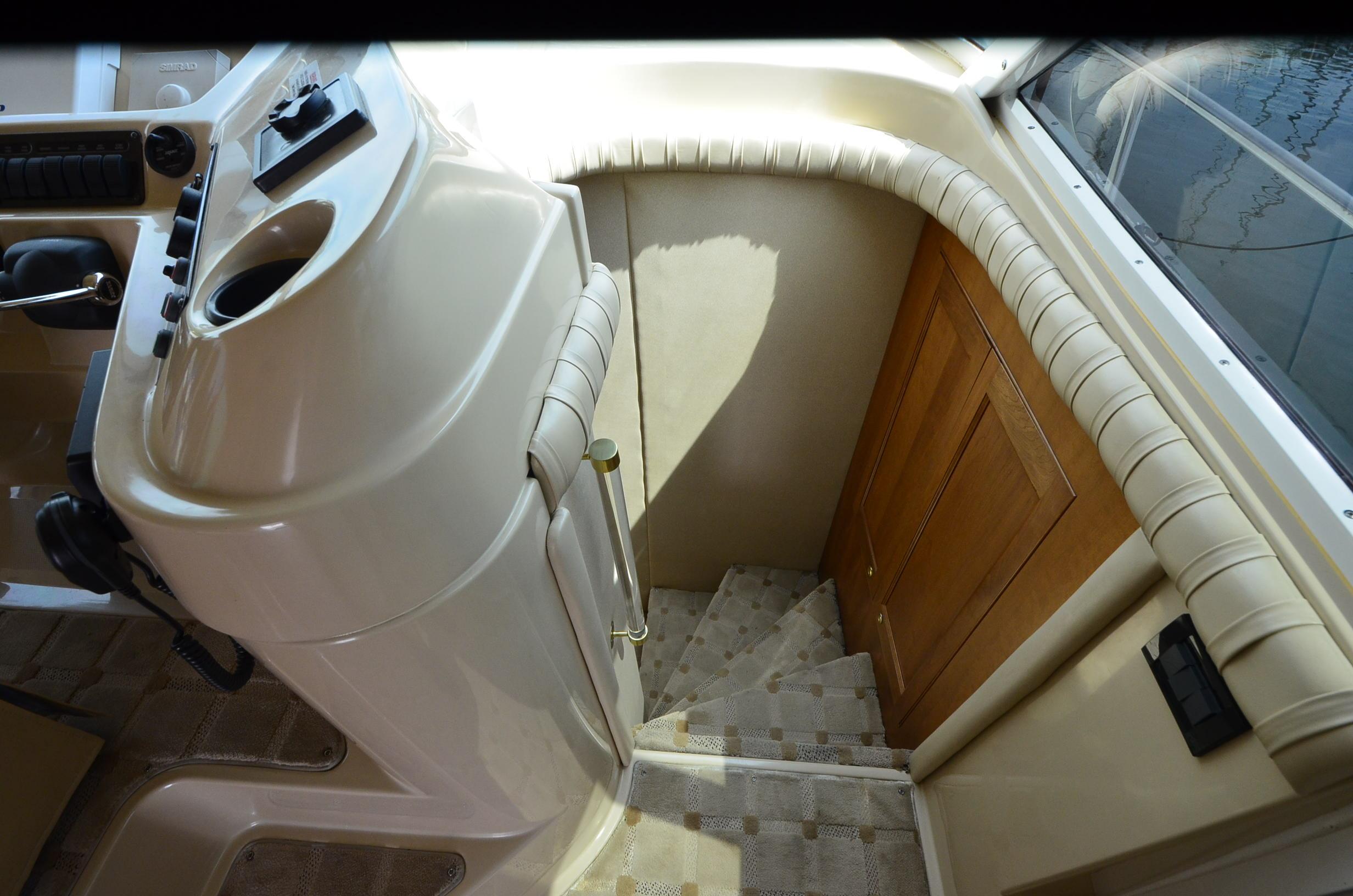 Interior of 2003 Cruisers Yachts 5000 Sedan Sport, featuring helm and staircase.