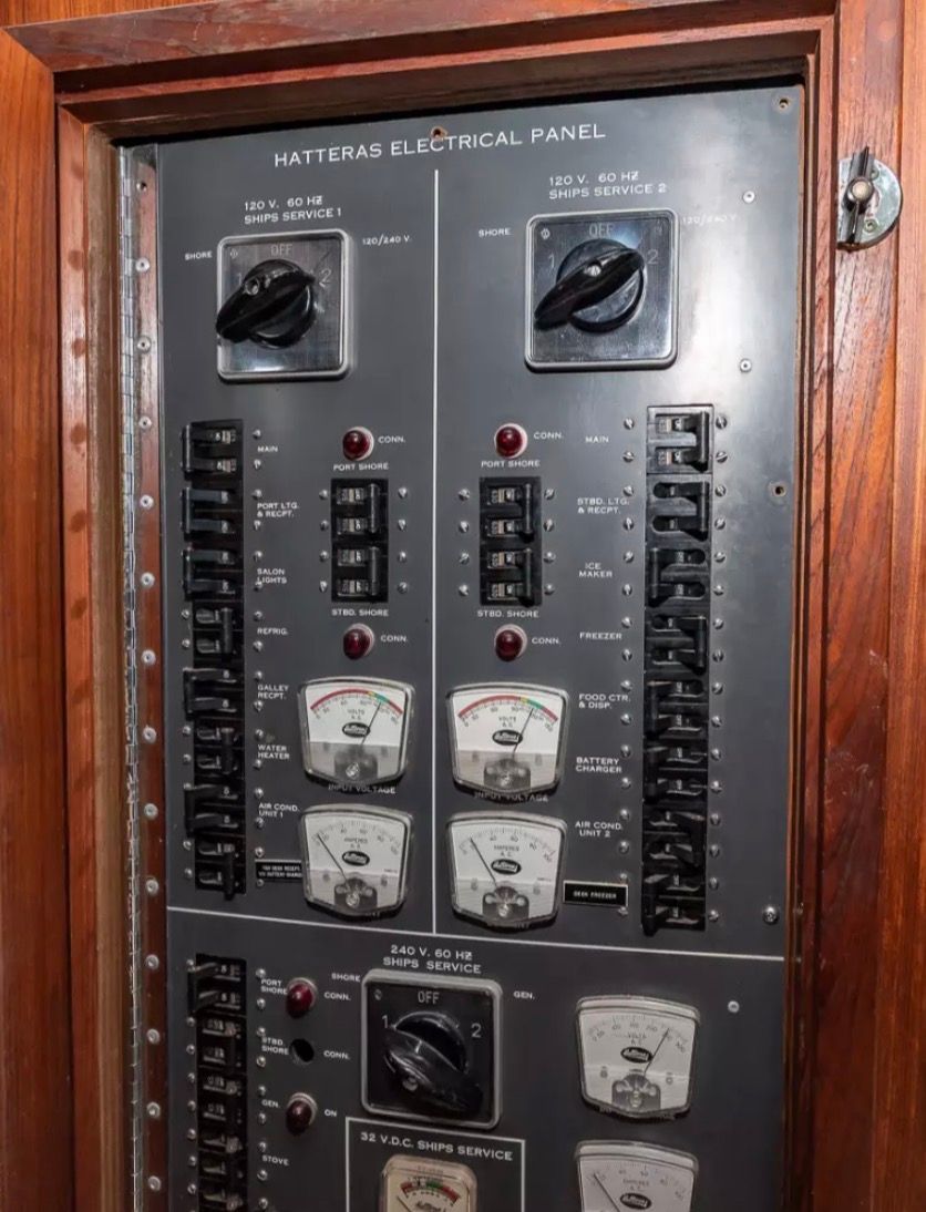 Electrical panel of a 1979 Hatteras sport fishing yacht with switches and gauges.