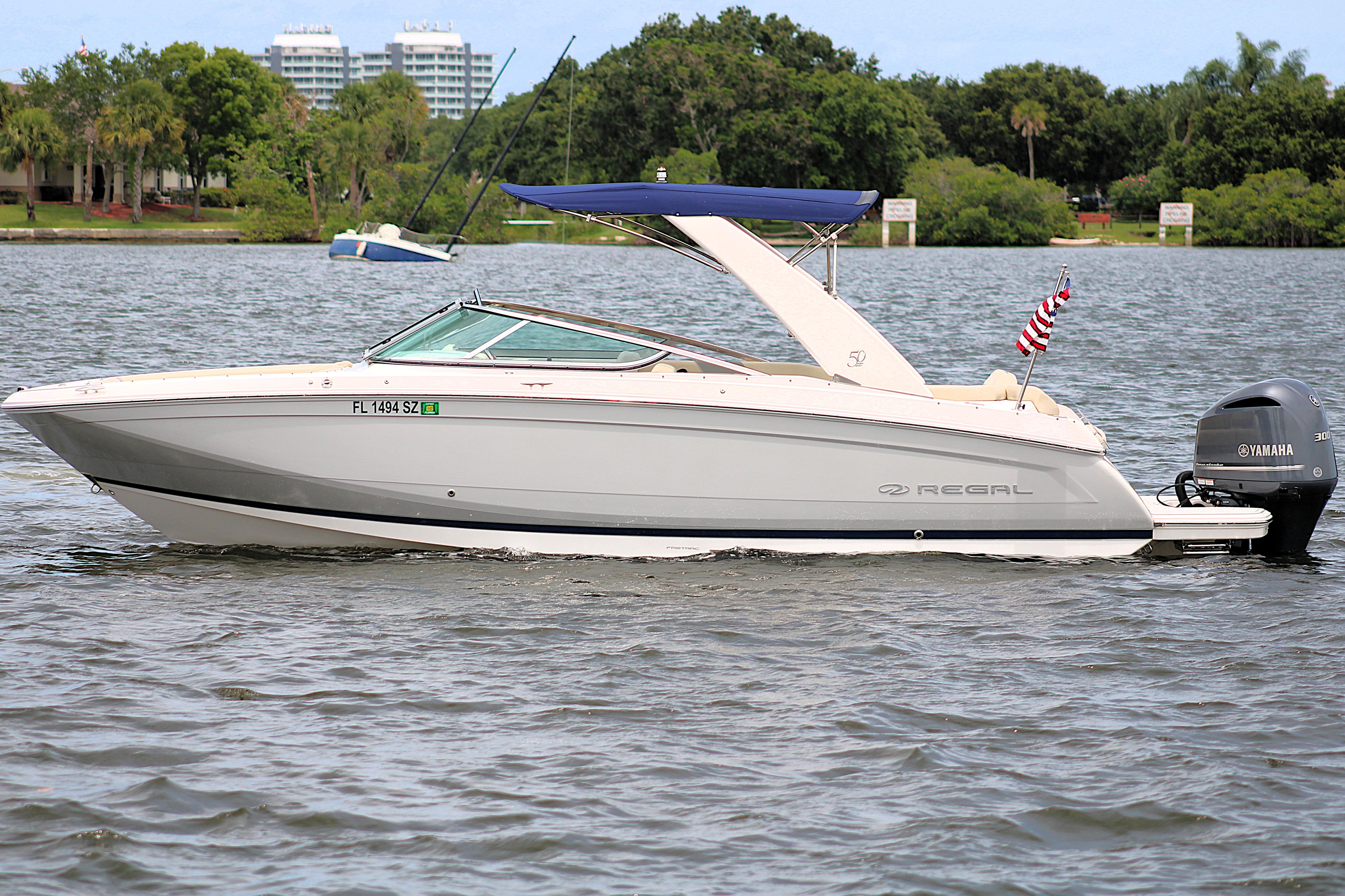 2021 Regal 26 OBX boat with Yamaha engine on a calm lake.