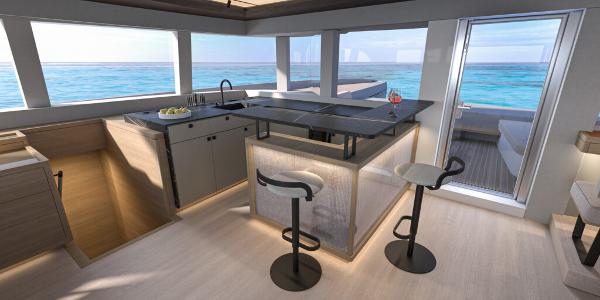 Modern interior of 2025 Lagoon 83 yacht with ocean view and sleek kitchen design.