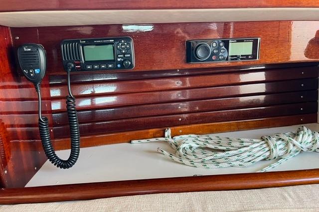 Wooden boat interior with communication devices and coiled rope, Morris 36, 2006 model.