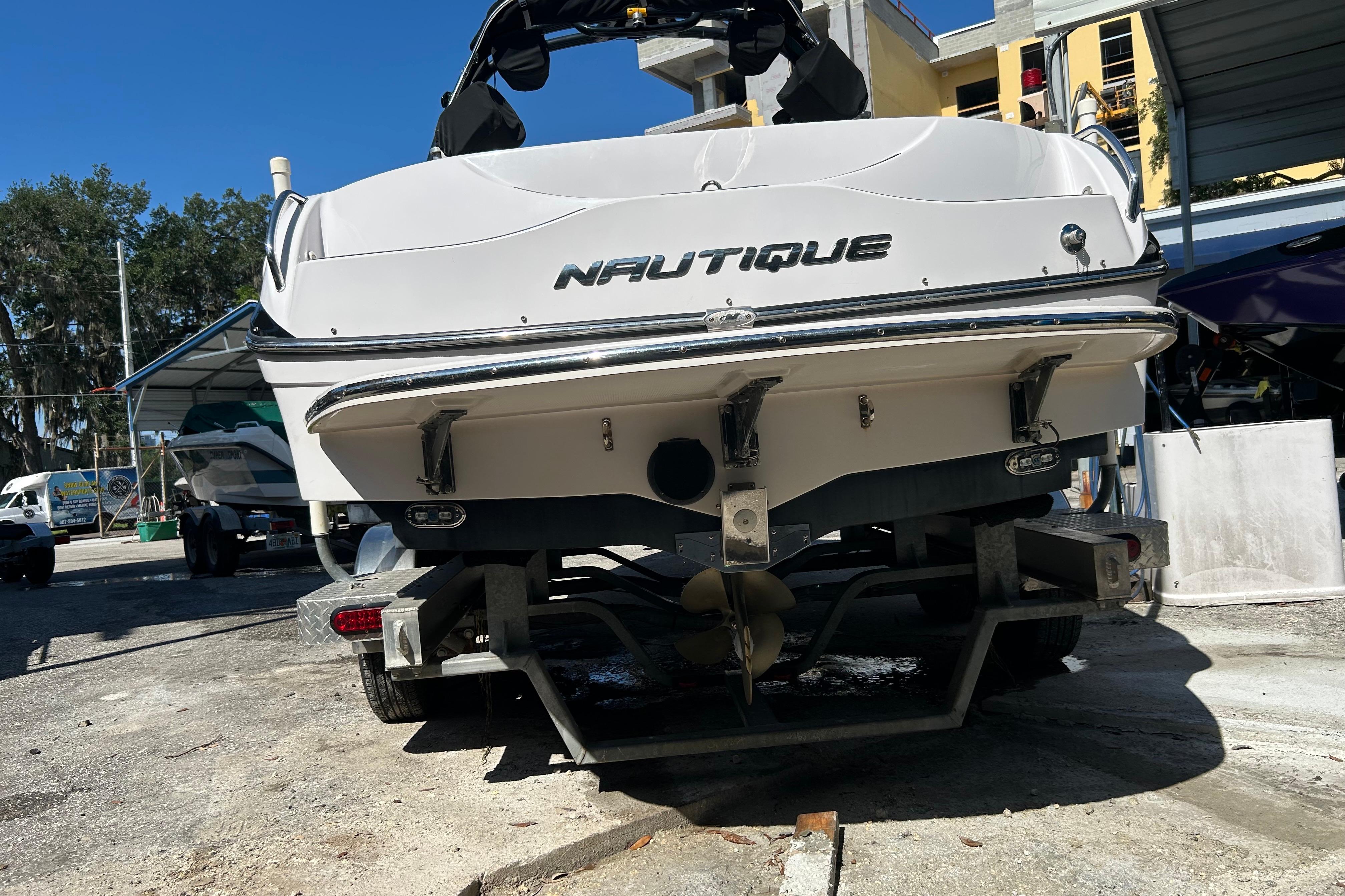 2010 Nautique Super Air Nautique 210 Coastal Edition boat on trailer, rear view.