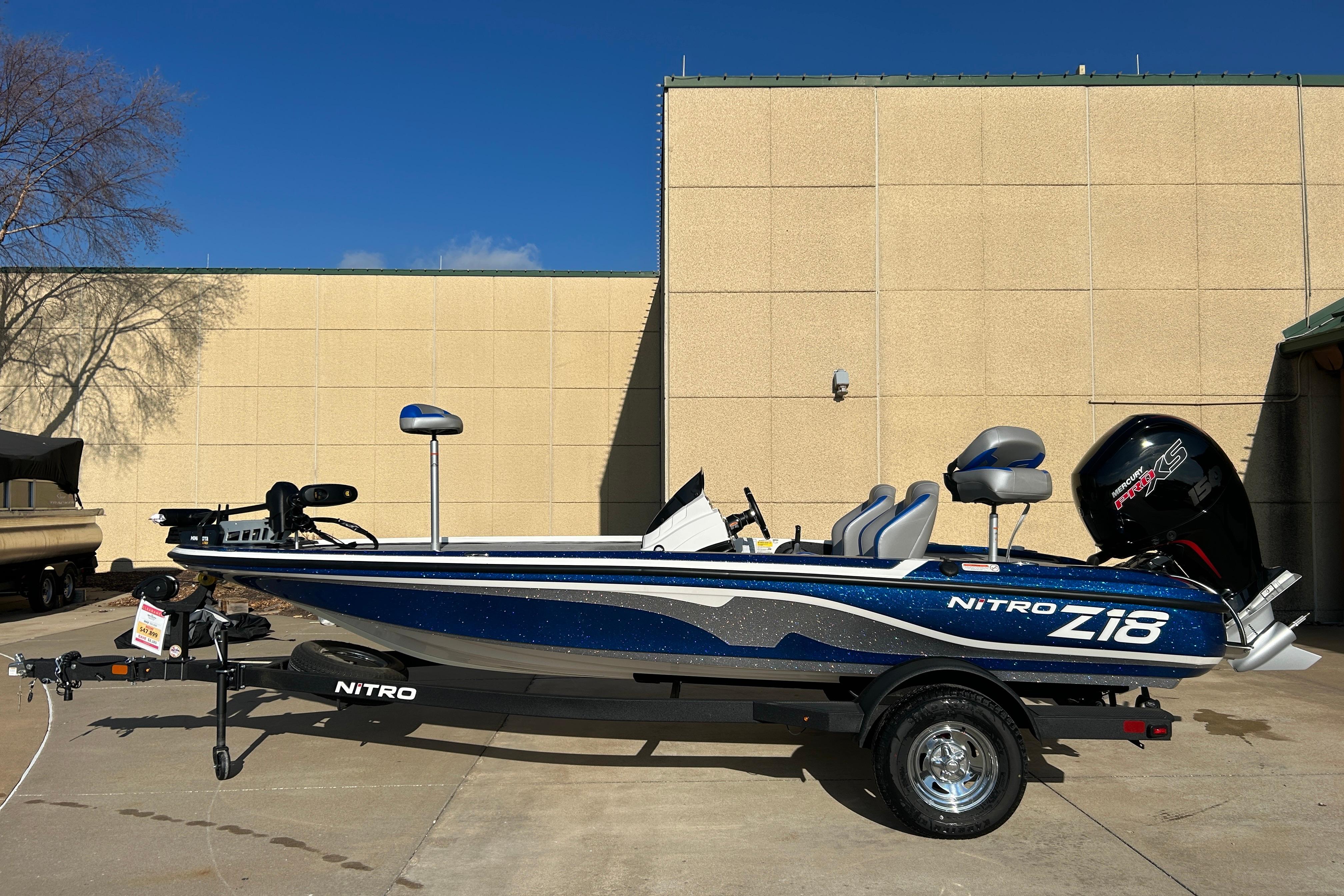 2025 Nitro Z18 Pro boat with trailer, parked outdoors under clear blue sky.