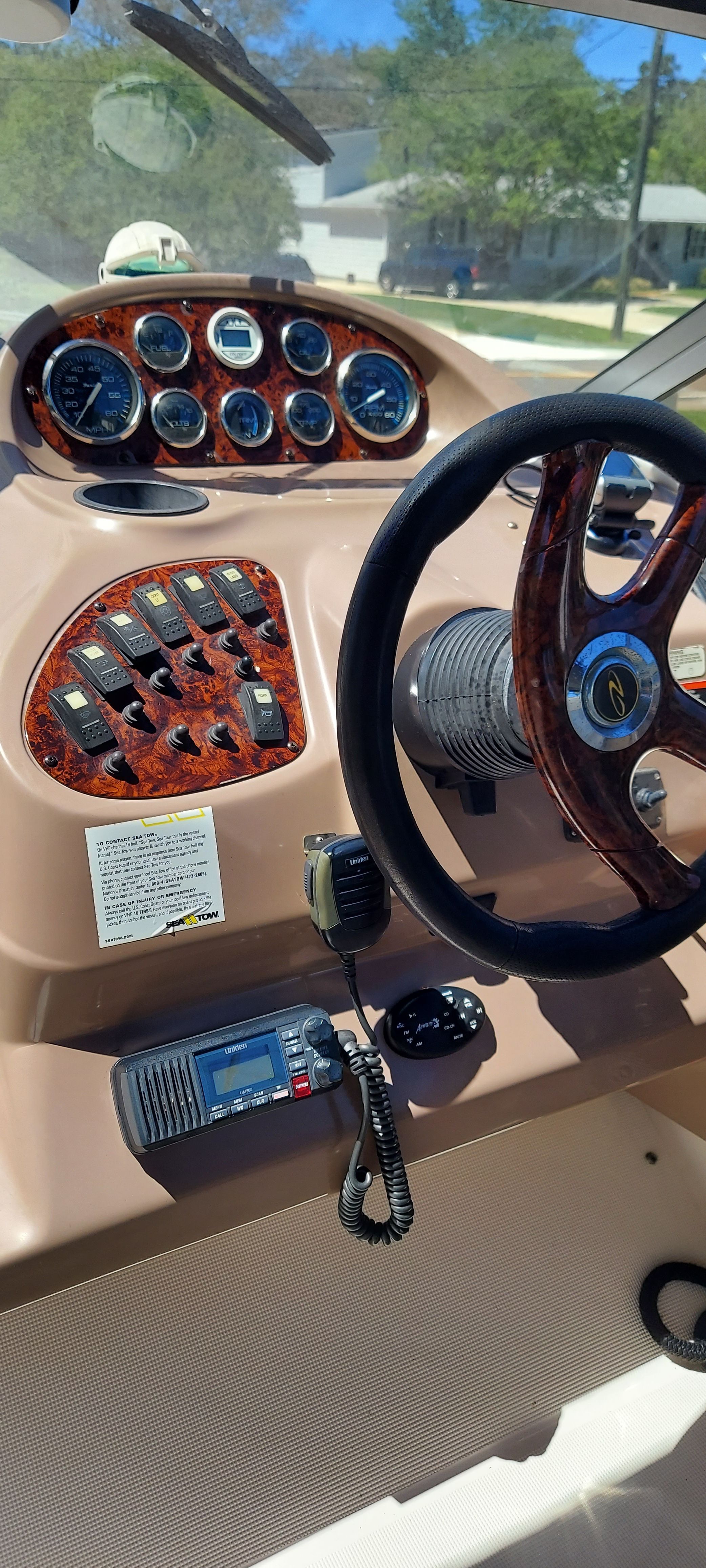 Dashboard of a 2004 Regal Commodore 2465 boat with wood trim.