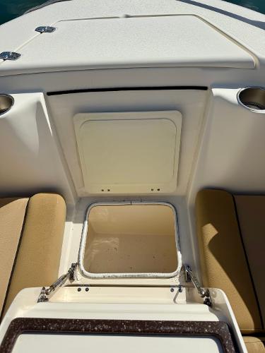 2016 Scout 245 Dorado boat interior with storage compartment and seating.