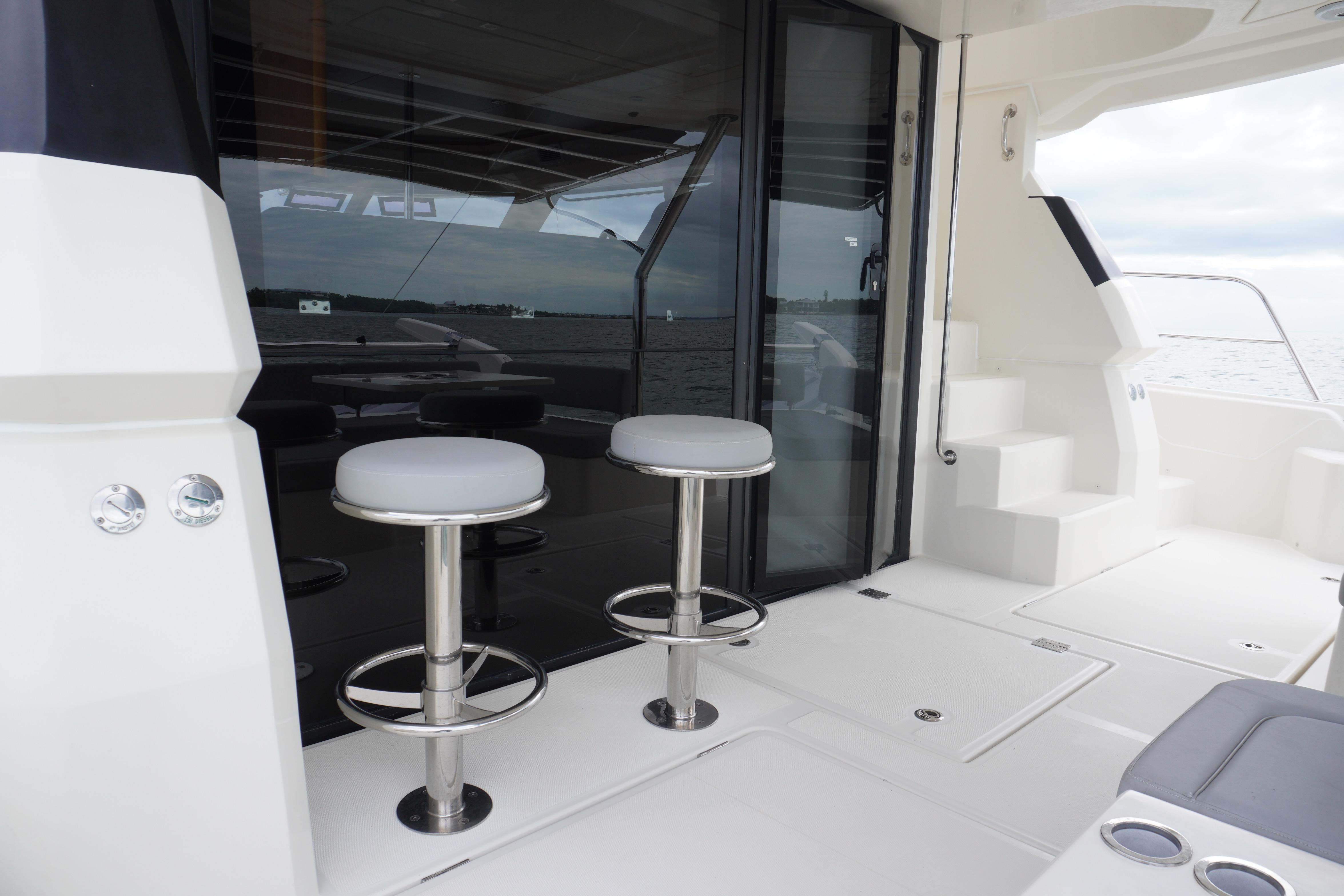 2017 Aquila 44 Yacht deck with bar stools and glass doors.
