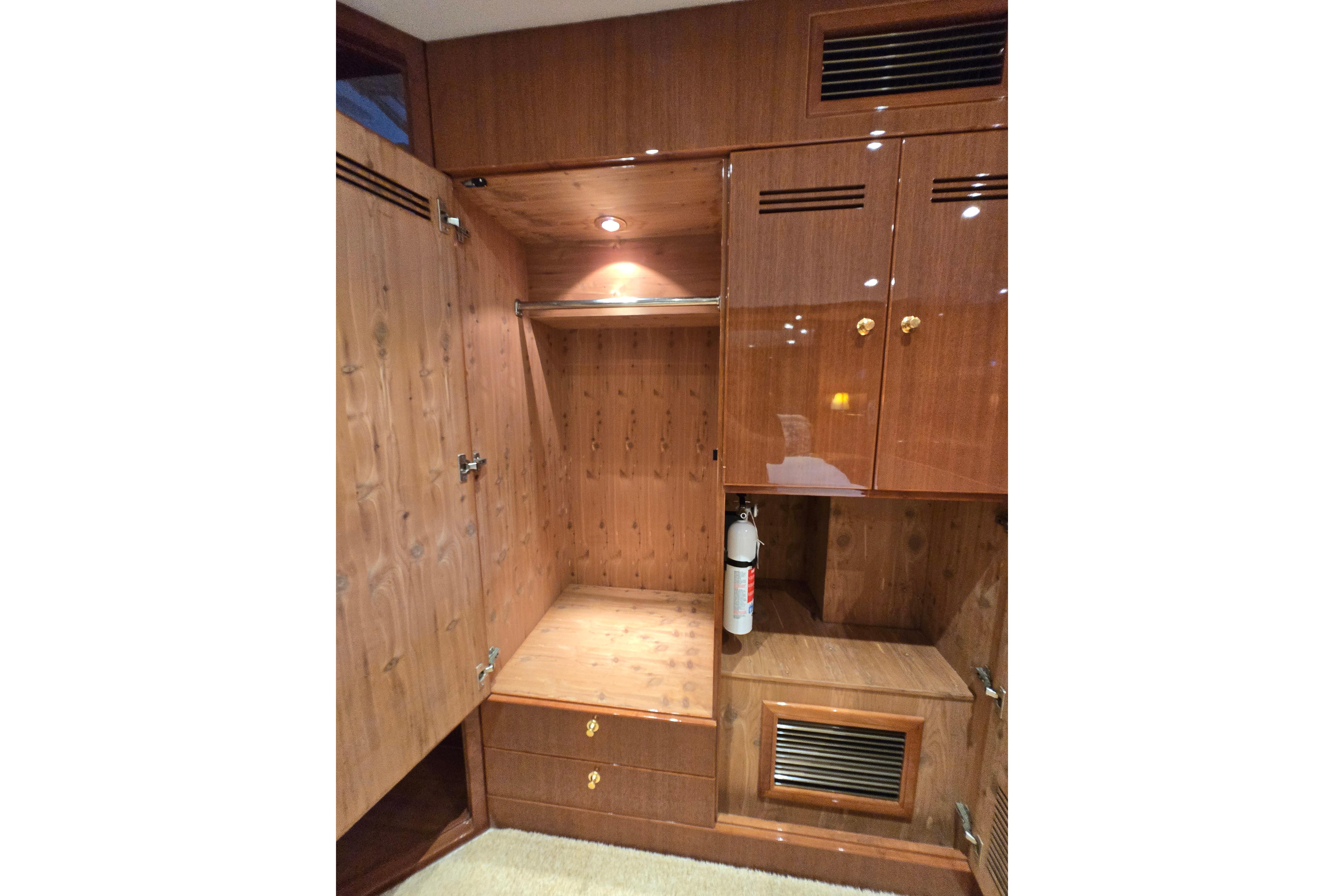Luxurious wooden interior of 2004 Grand Harbour 58 yacht with storage and fire extinguisher.