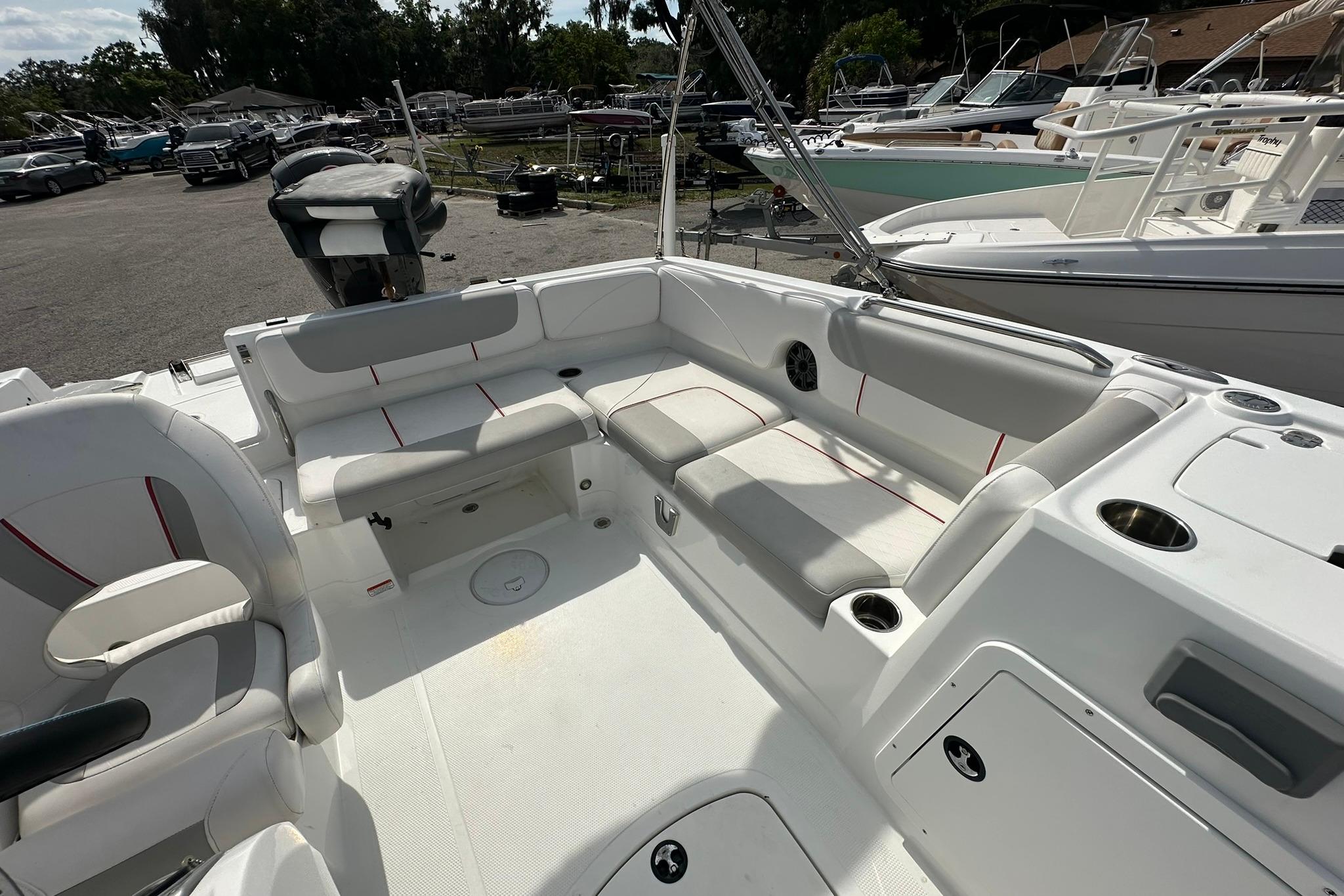 2021 Tahoe 2150 boat interior with spacious seating and modern design in a marina setting.