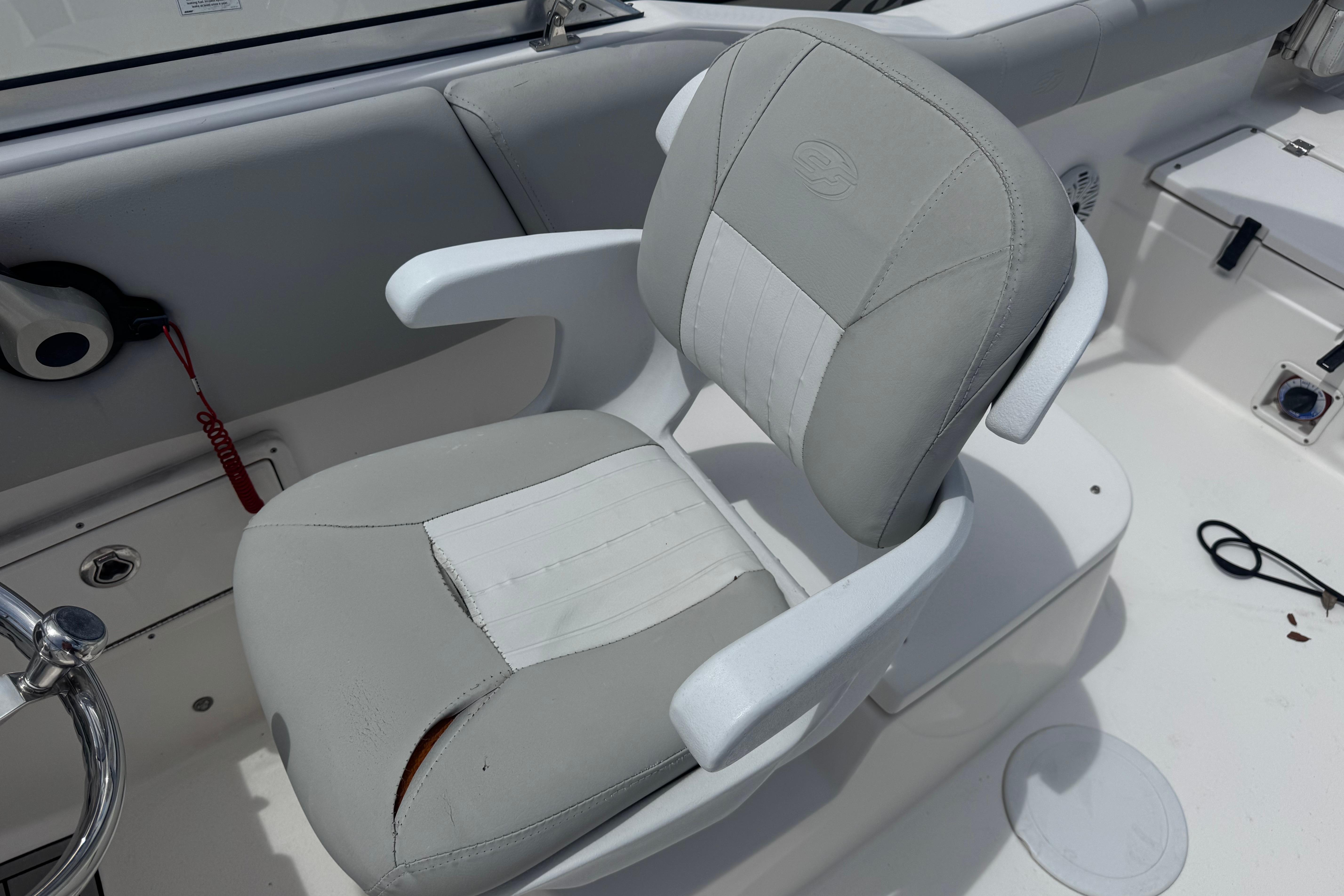 Captain's chair on 2020 Sea Fox 226 Traveler boat, featuring white and gray upholstery.