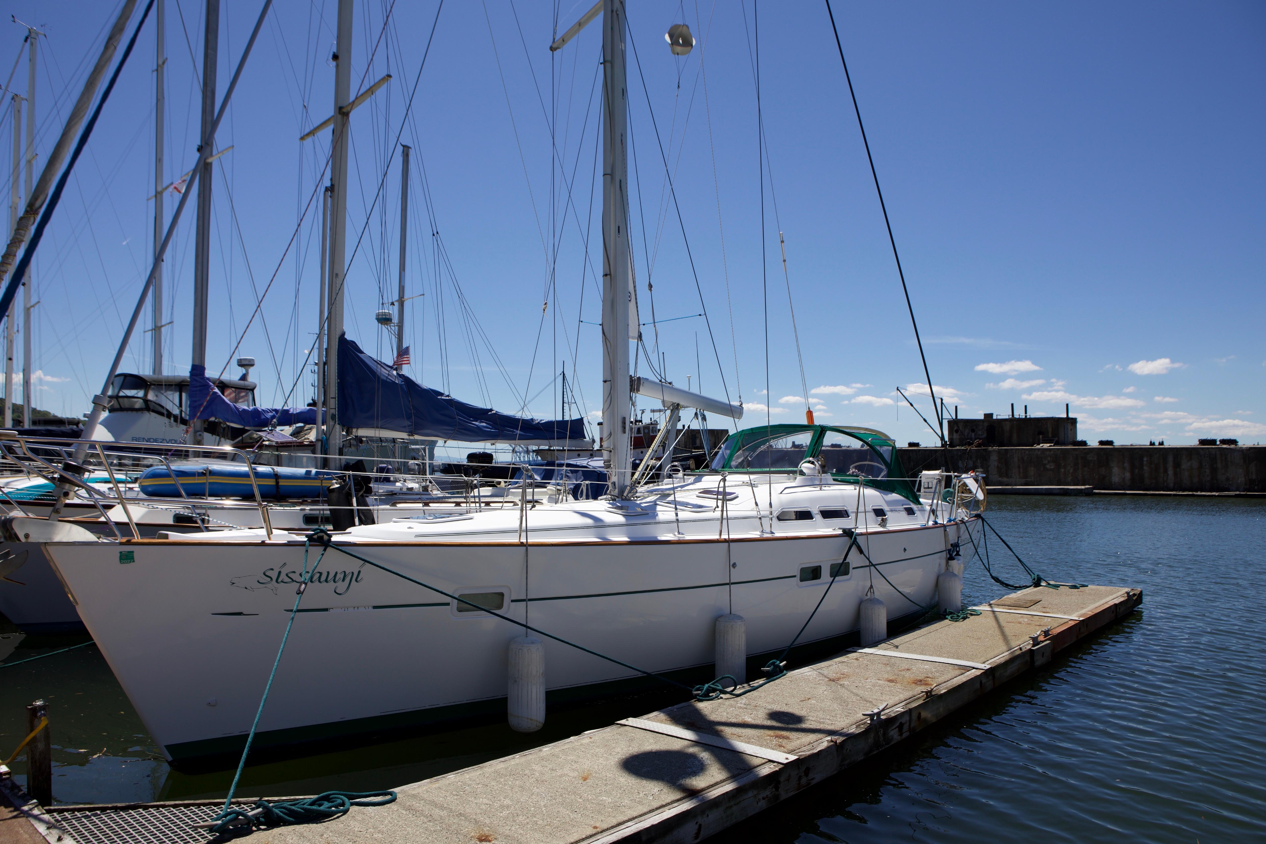 2005 Beneteau 423 sailboat docked at marina under clear blue sky.