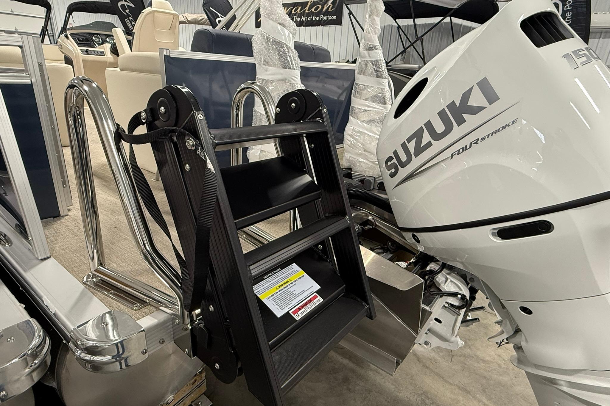 2026 Avalon LSZ Elite 21' with Suzuki outboard motor and boarding ladder.