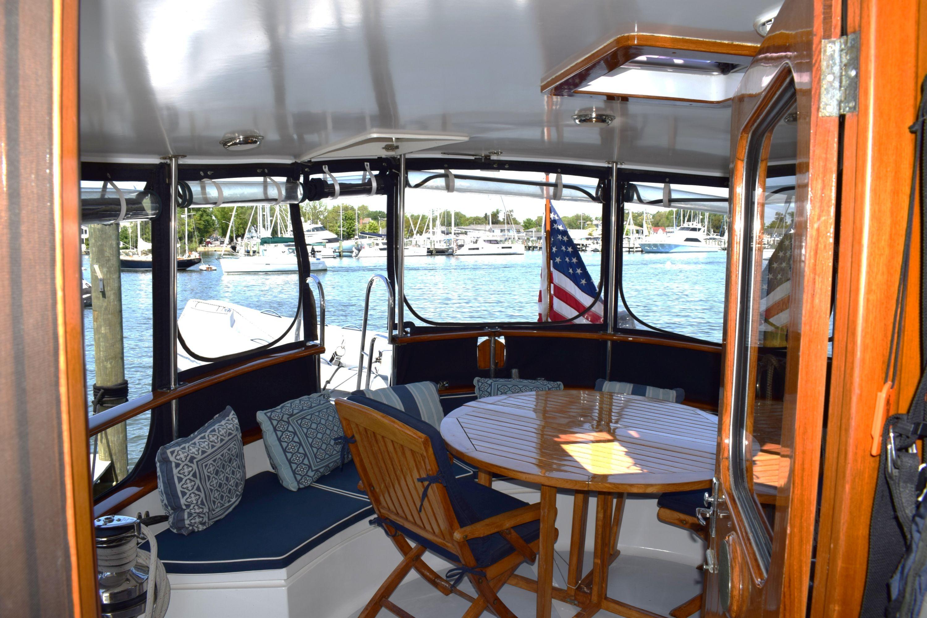 Interior view of 1980 Cheoy Lee 52 Motorsailer with seating and table, overlooking marina.
