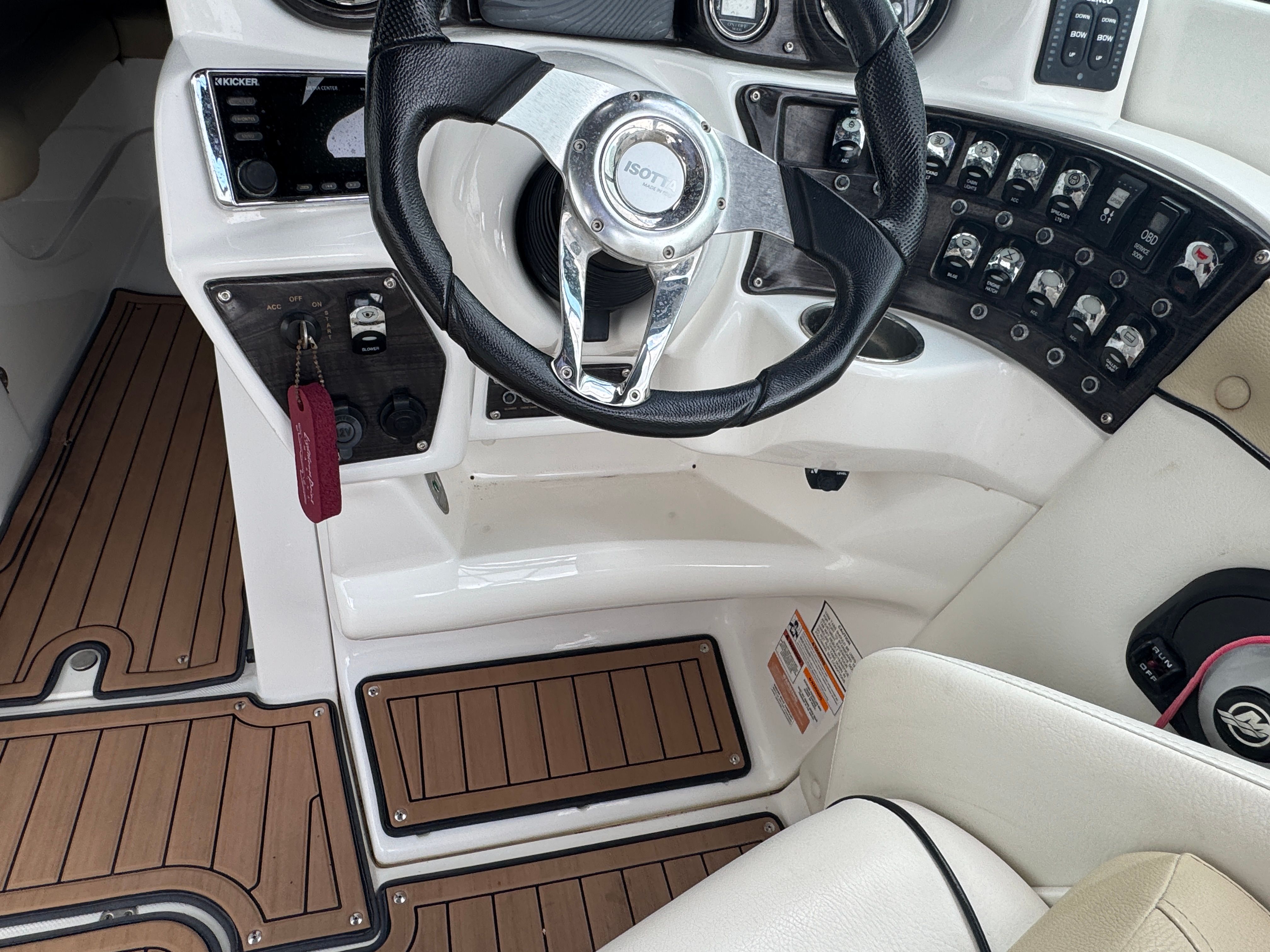 2017 Rinker QX29 BR boat helm with wood-look flooring.