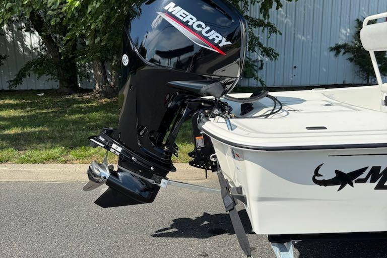 2026 Mako Pro Skiff 17 CC with Mercury outboard motor, parked outdoors.