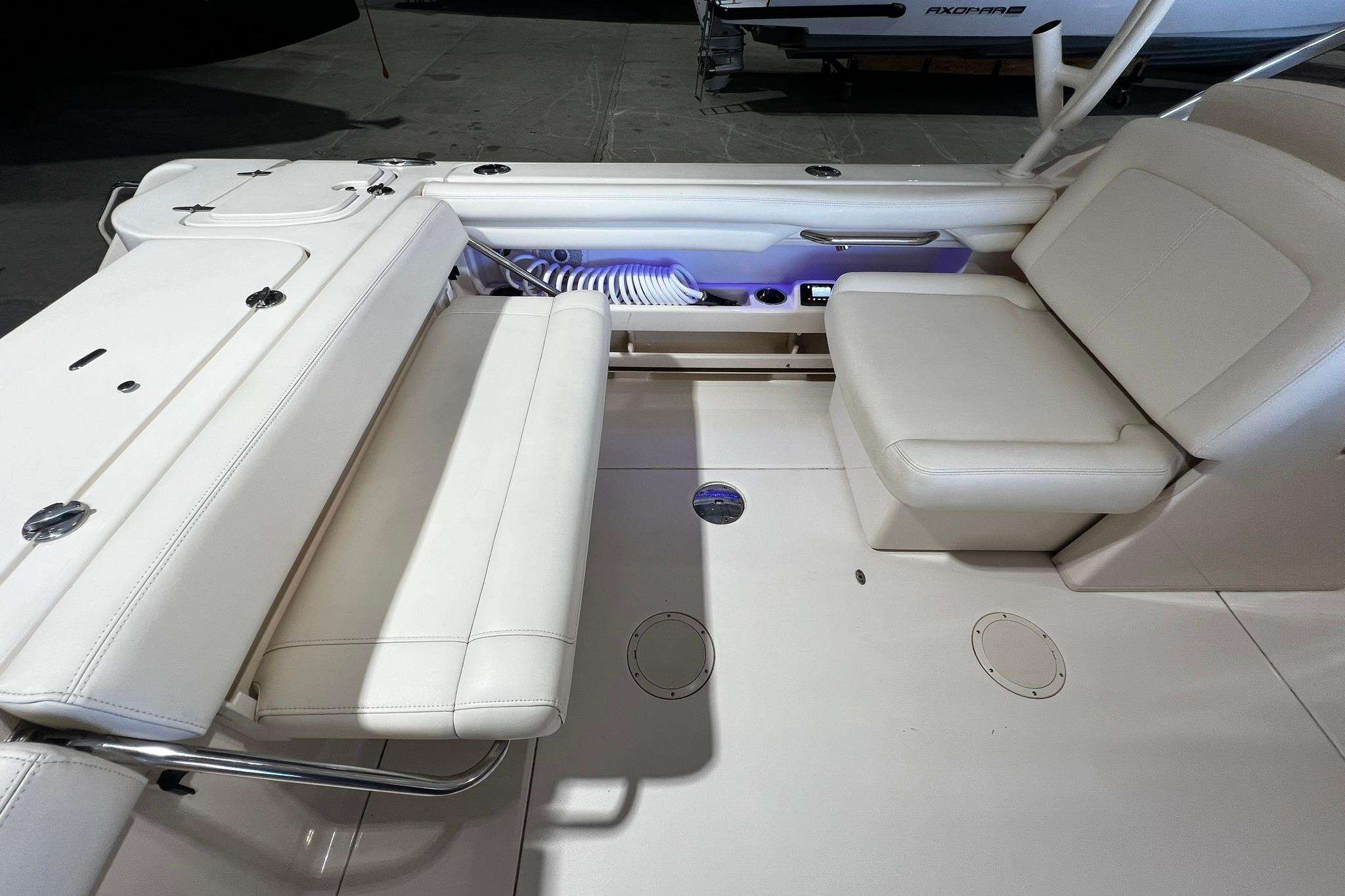 2014 Grady-White Freedom 275 boat interior with white seating and storage compartments.