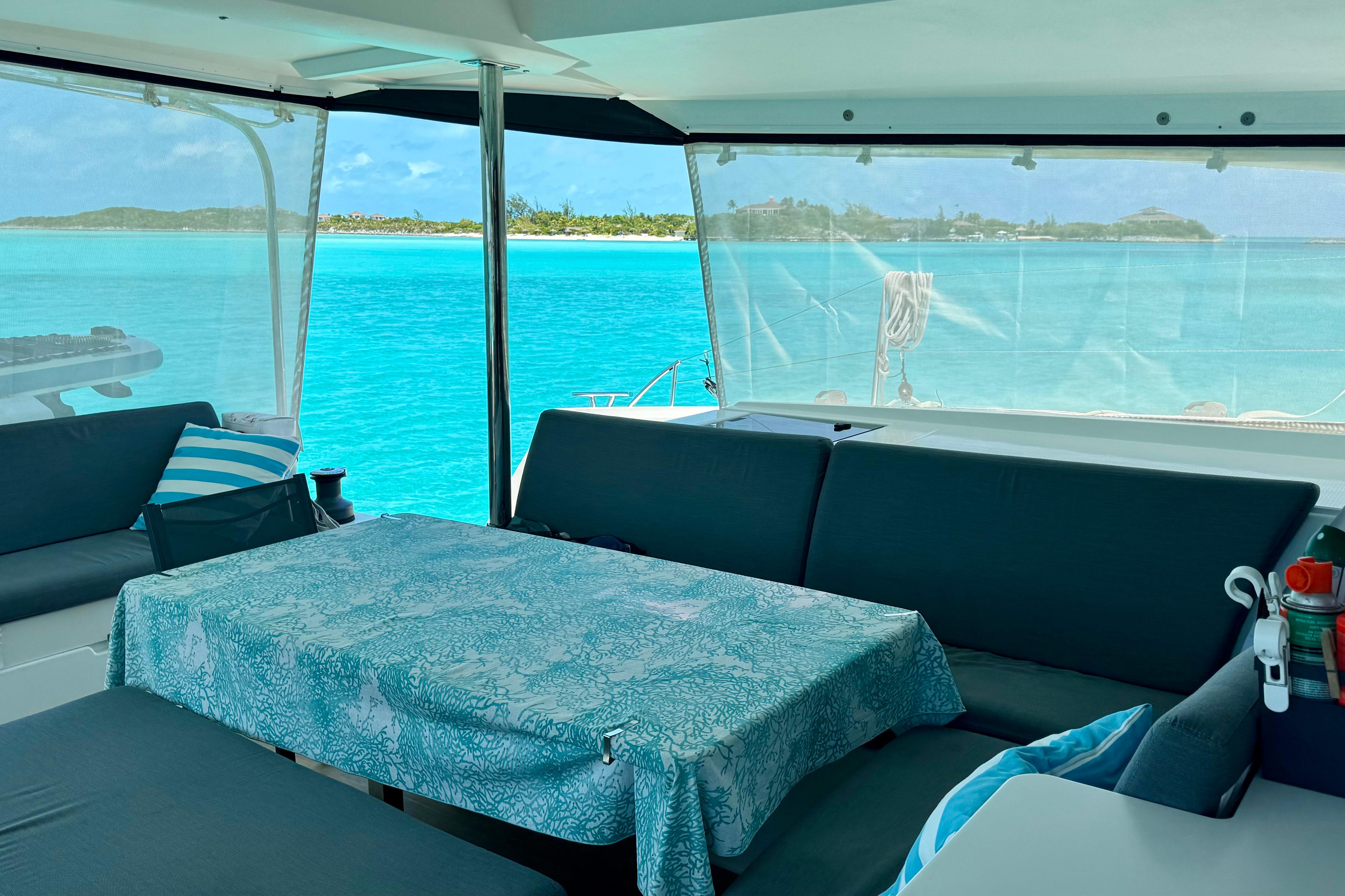 Interior of 2020 Fountaine Pajot Saona 47 catamaran with ocean view and cozy seating area.