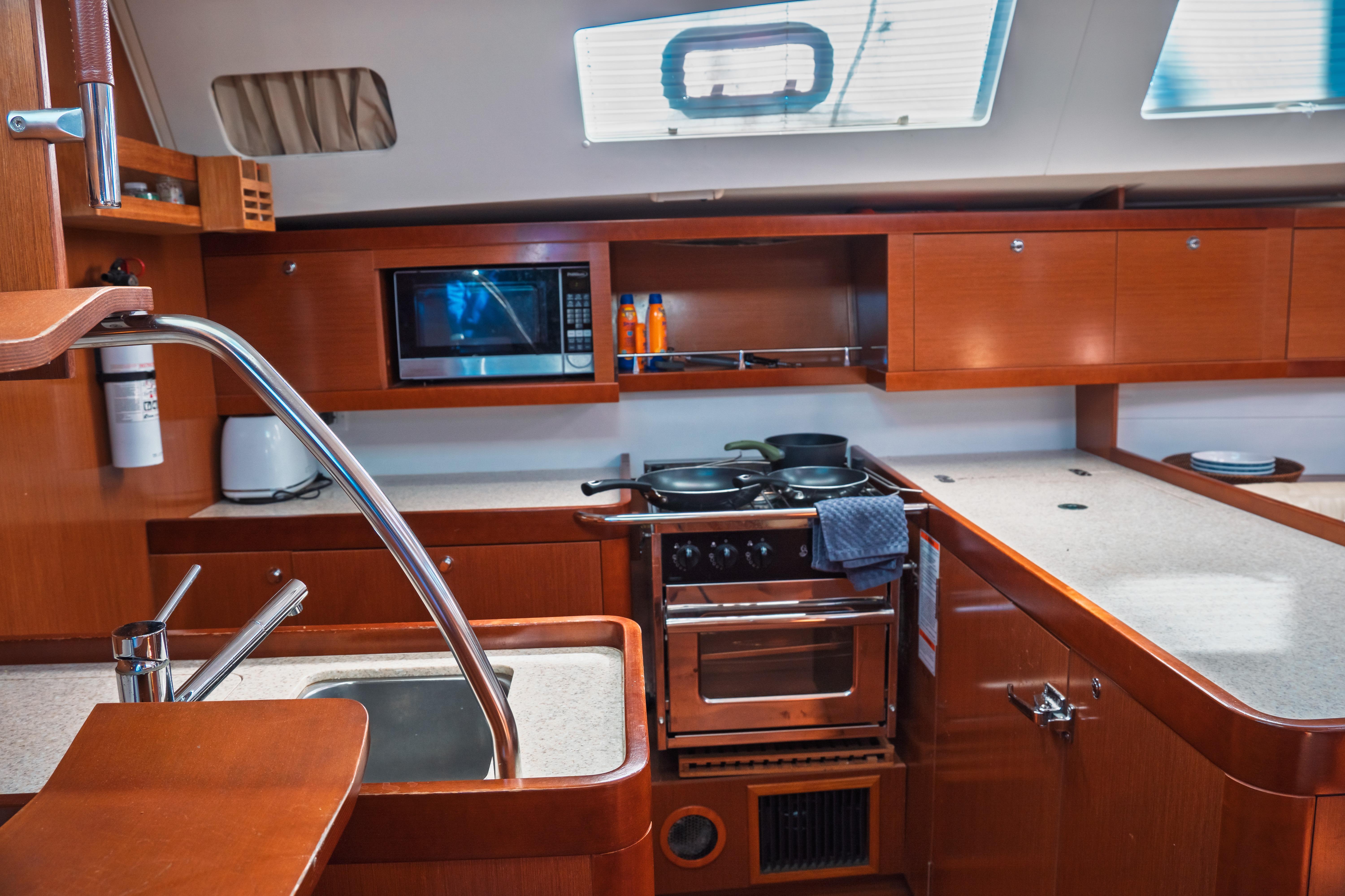 Interior of 2011 Beneteau Oceanis 50 yacht kitchen with modern amenities.