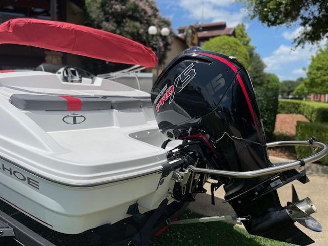 2024 Tahoe T18 boat with a powerful outboard motor, featuring sleek design and red accents.