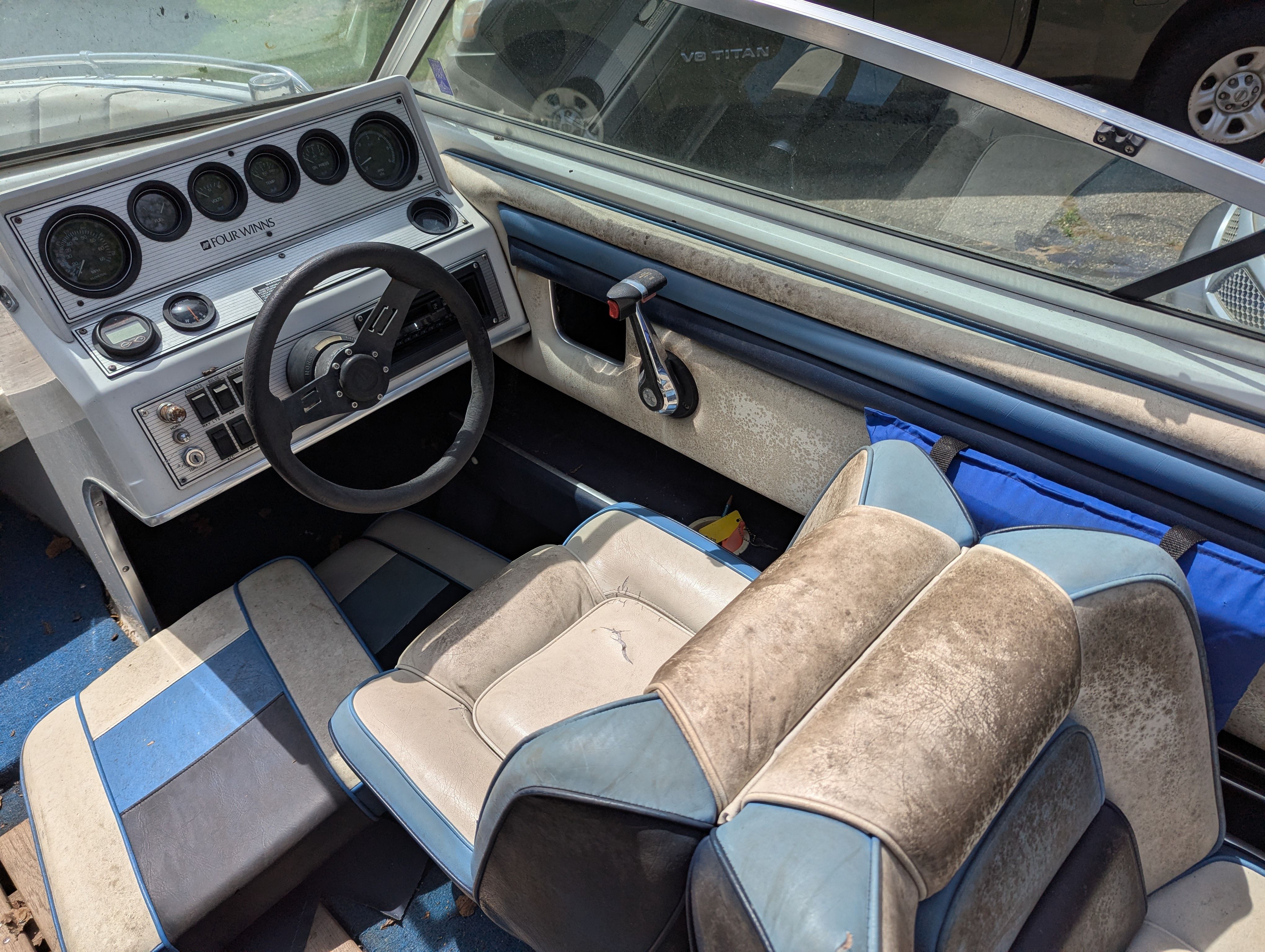 Interior of a 1988 Four Winns 200 Horizon boat with steering console.
