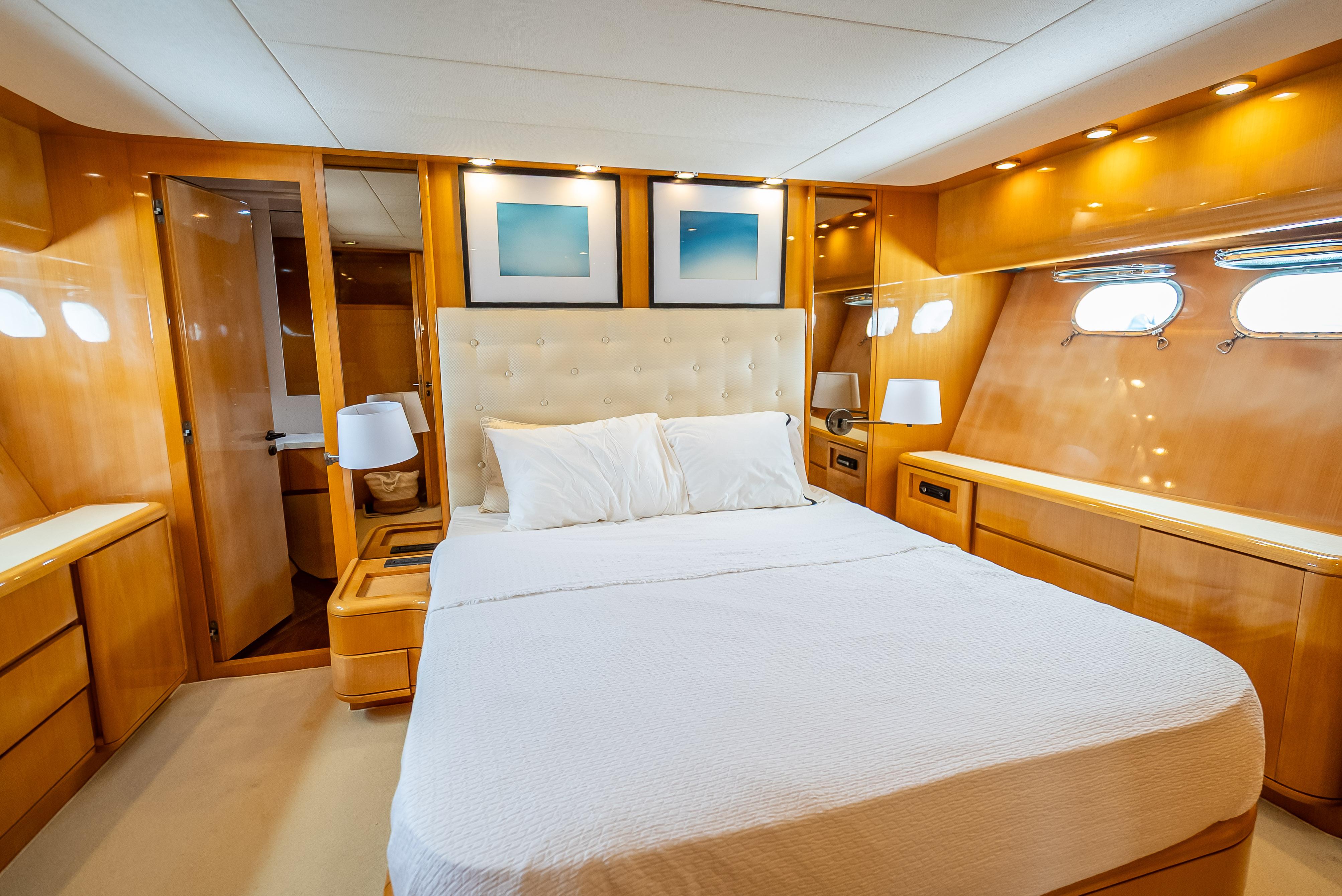 Luxurious cabin interior of 1995 Sanlorenzo 62 yacht with elegant wood finish.