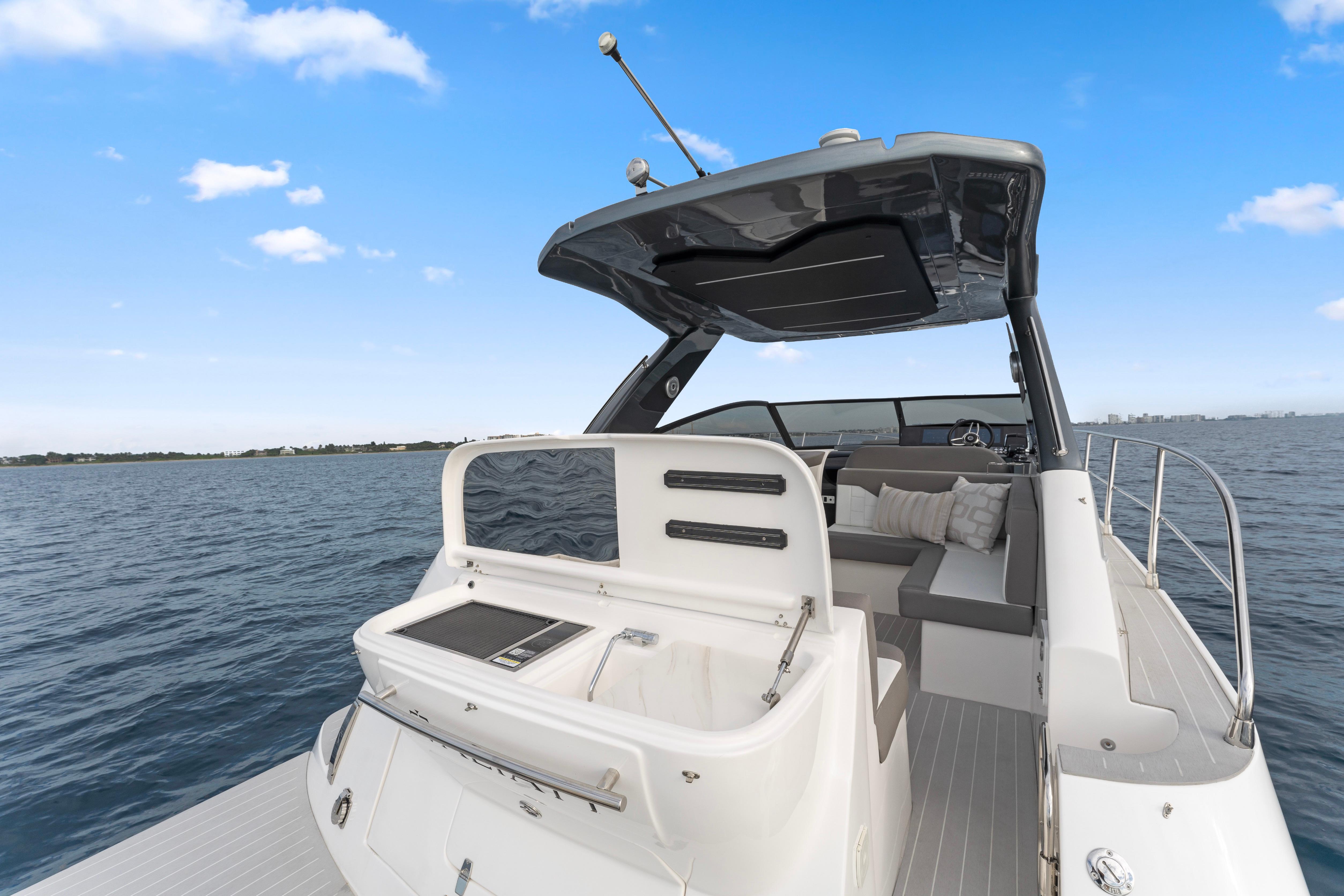 Luxury Valiatt 380GT yacht, 2025 model, cruising on open water under clear blue skies.