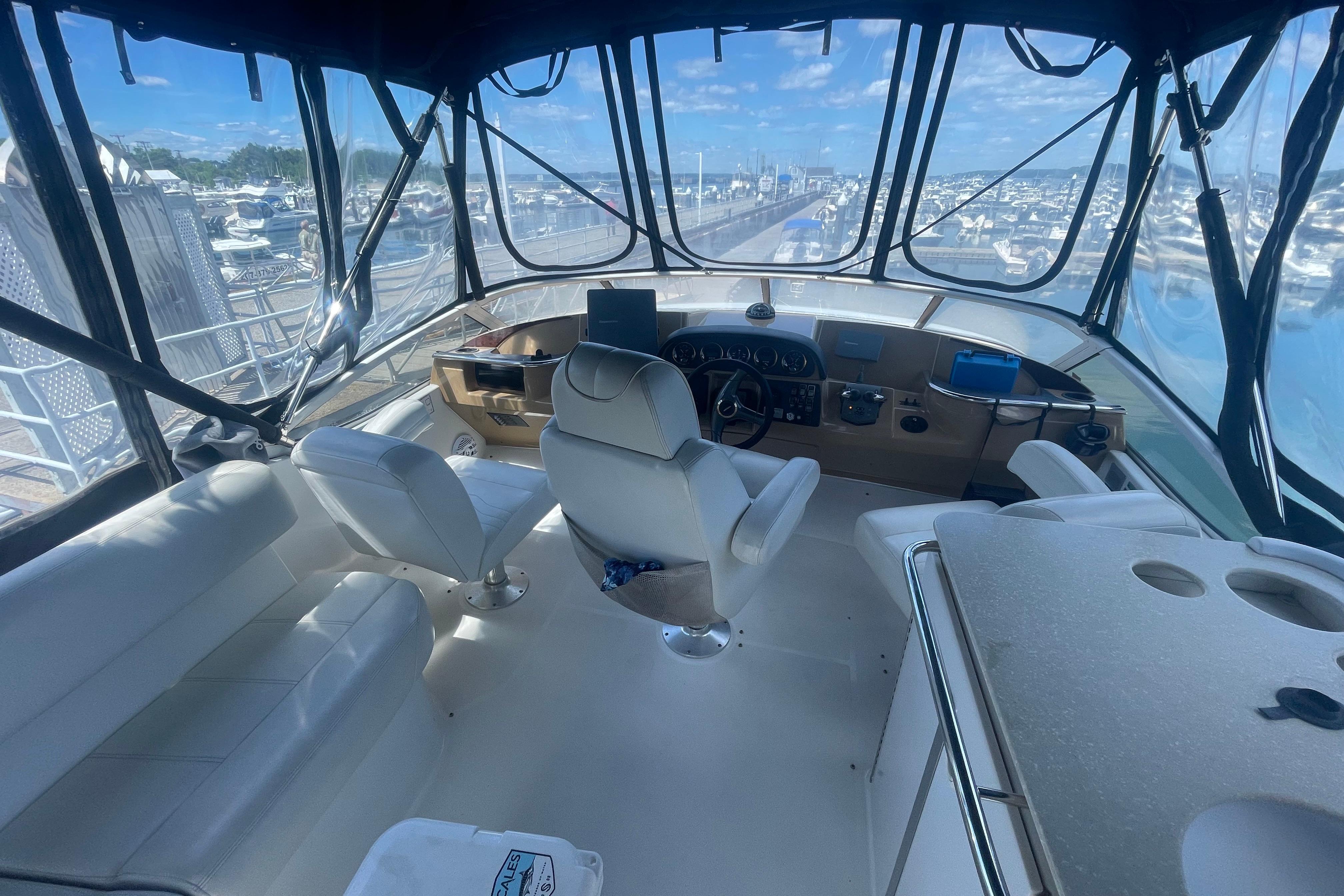 Interior view of 2002 Carver 410 Sport Sedan yacht cockpit with marina backdrop.
